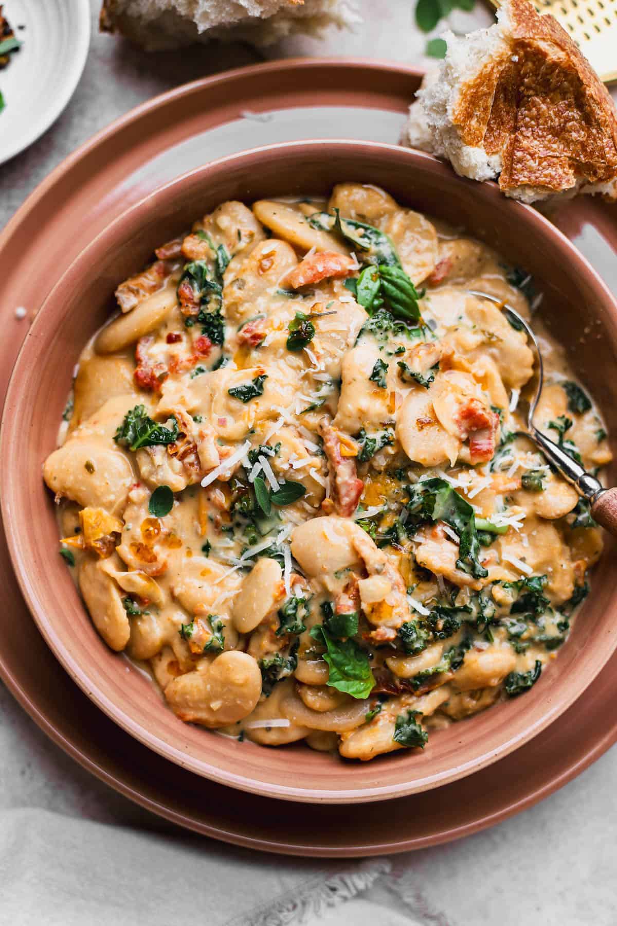 Marry me beans are made with butter beans, garlic, red chili flakes, basil, sun-dried tomatoes, kale, heavy cream and parmesan cheese. Served with crusty bread.