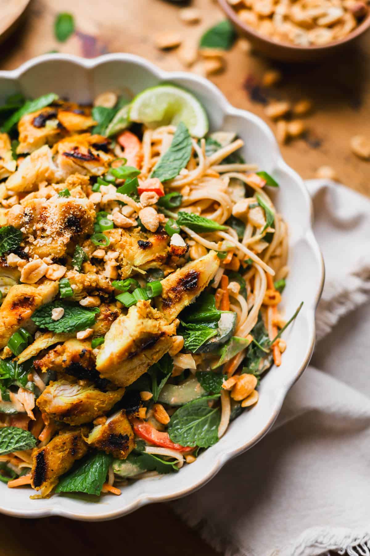 Thai chicken noodle salad with chicken satay, peanut dressing, fresh veggies, mint, and cilantro.  