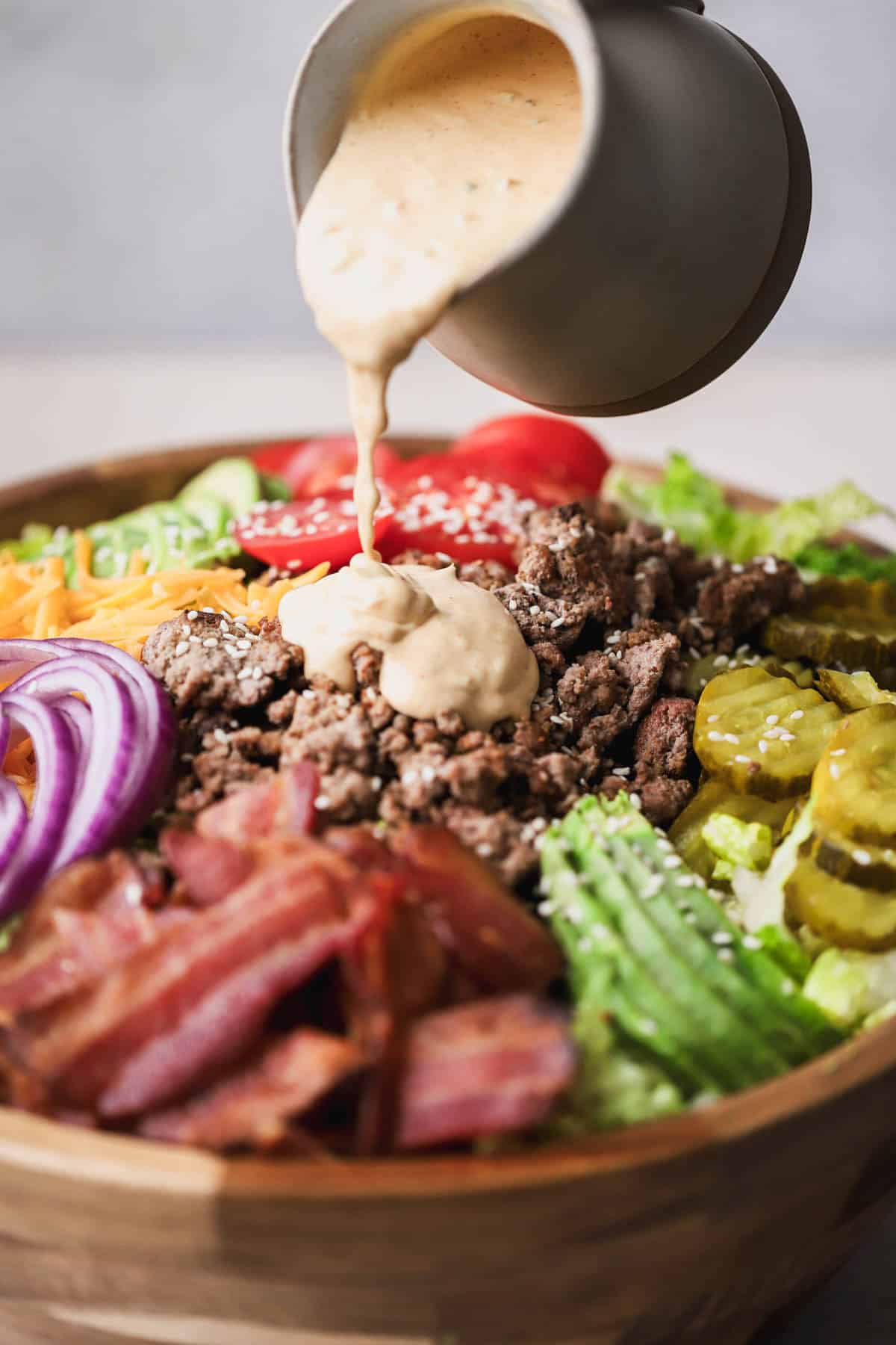 Deconstructed burger bowl drizzled with homemade special burger sauce.