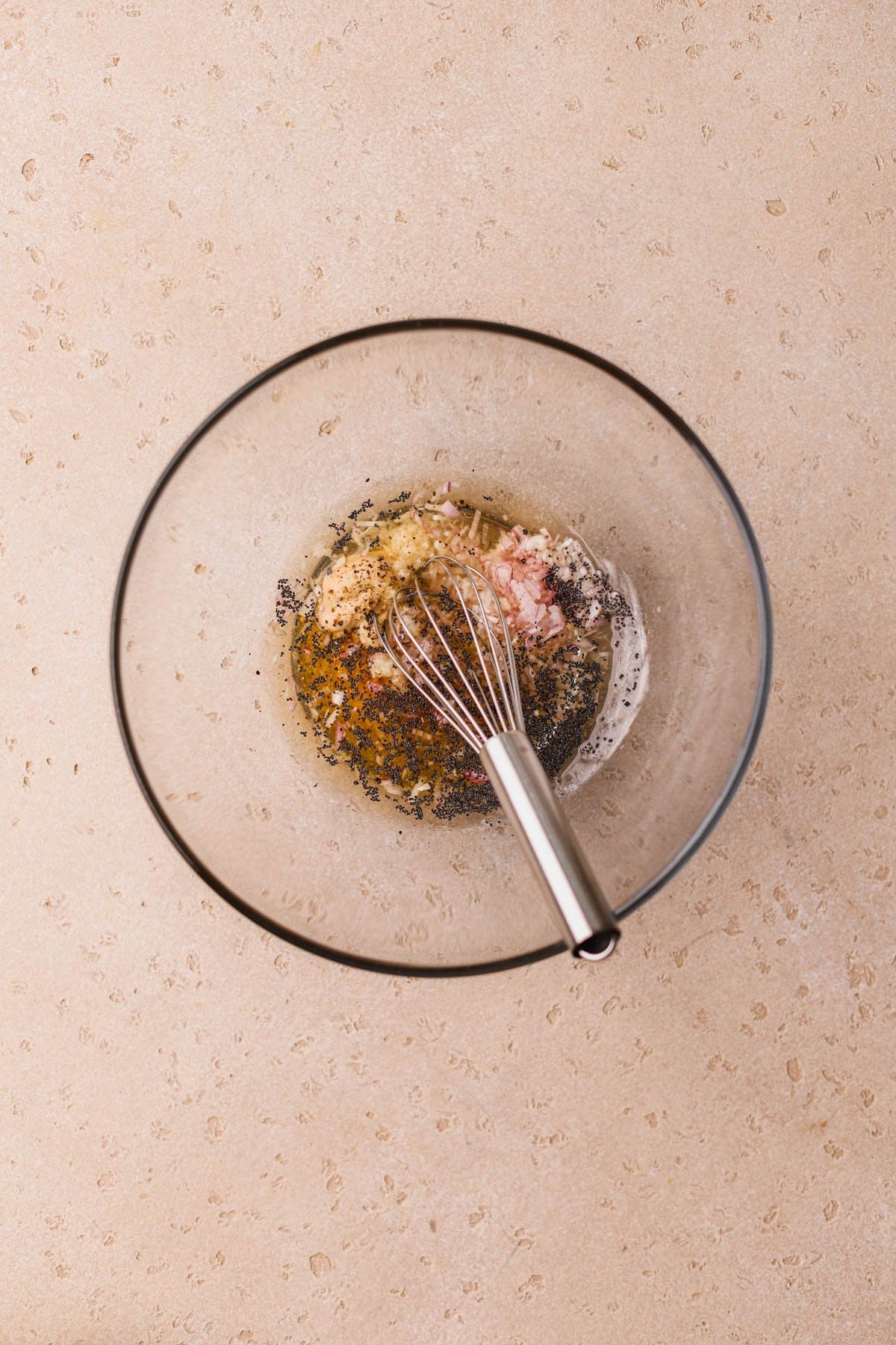 Honey, apple cider vinegar, garlic, poppyseeds, dijon, shallots, salt and pepper.  