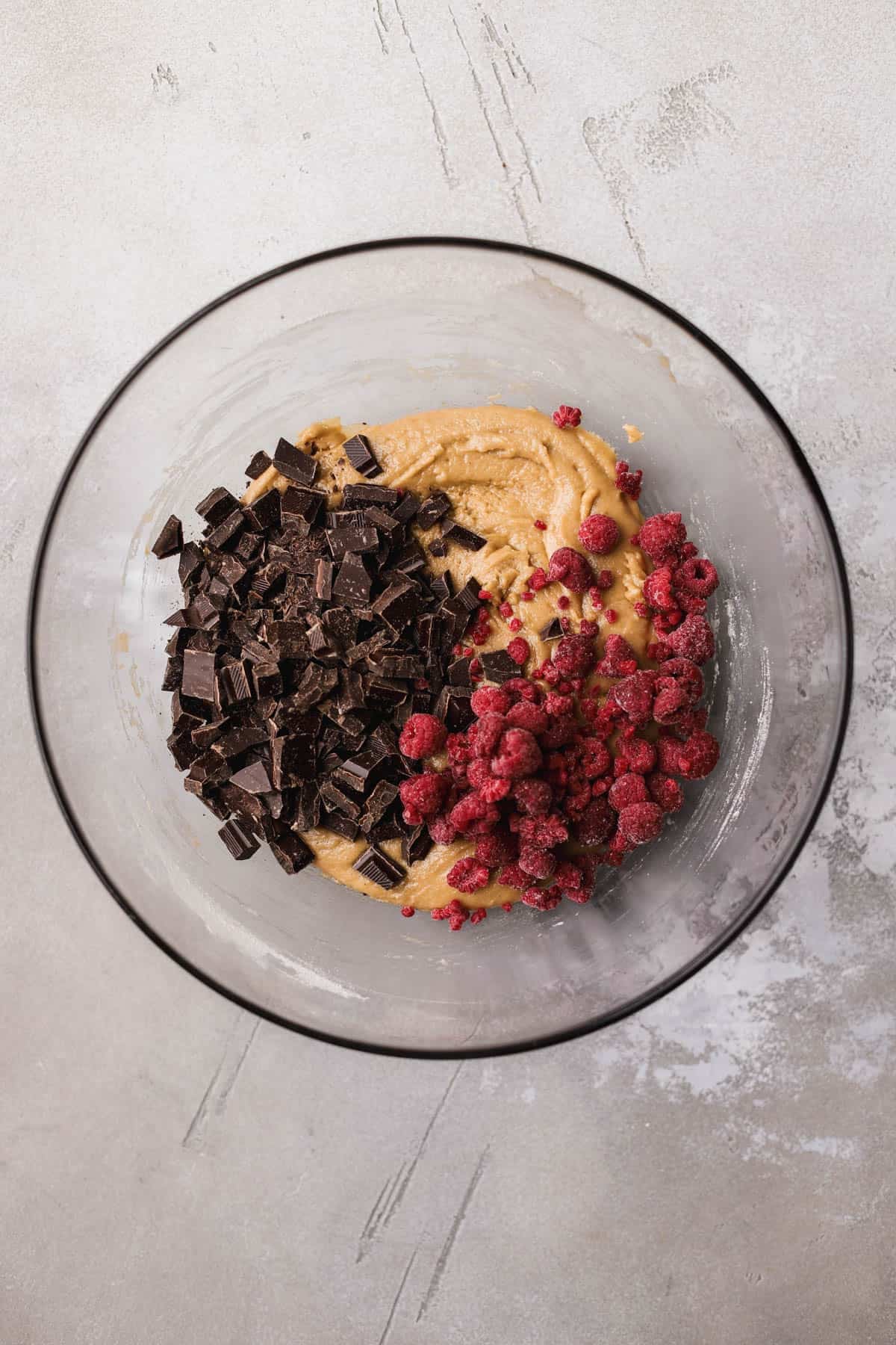 Cookie dough with chocolate chunks and frozen raspberries. 