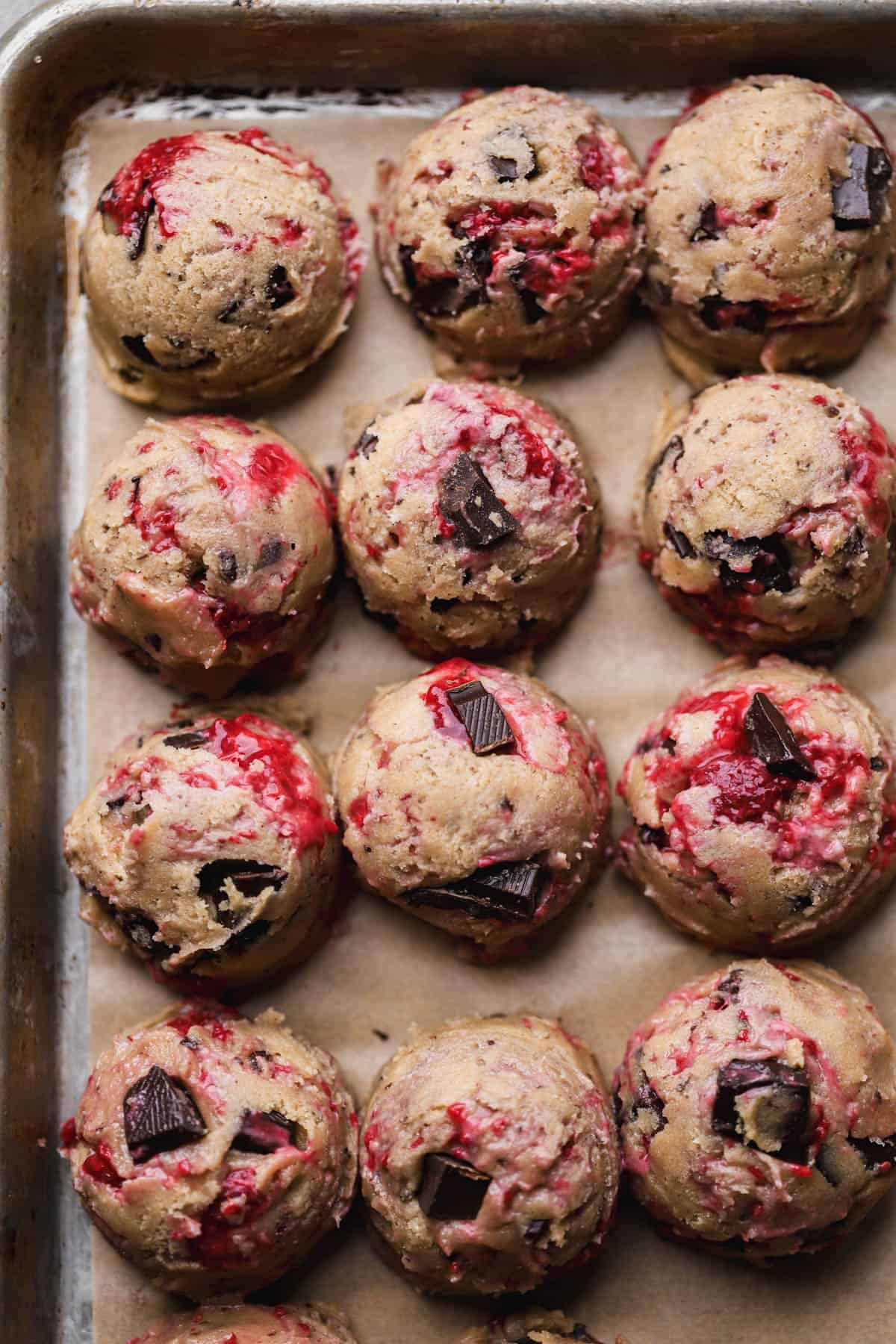Scooped raspberry cookies with chocolate chunks. 