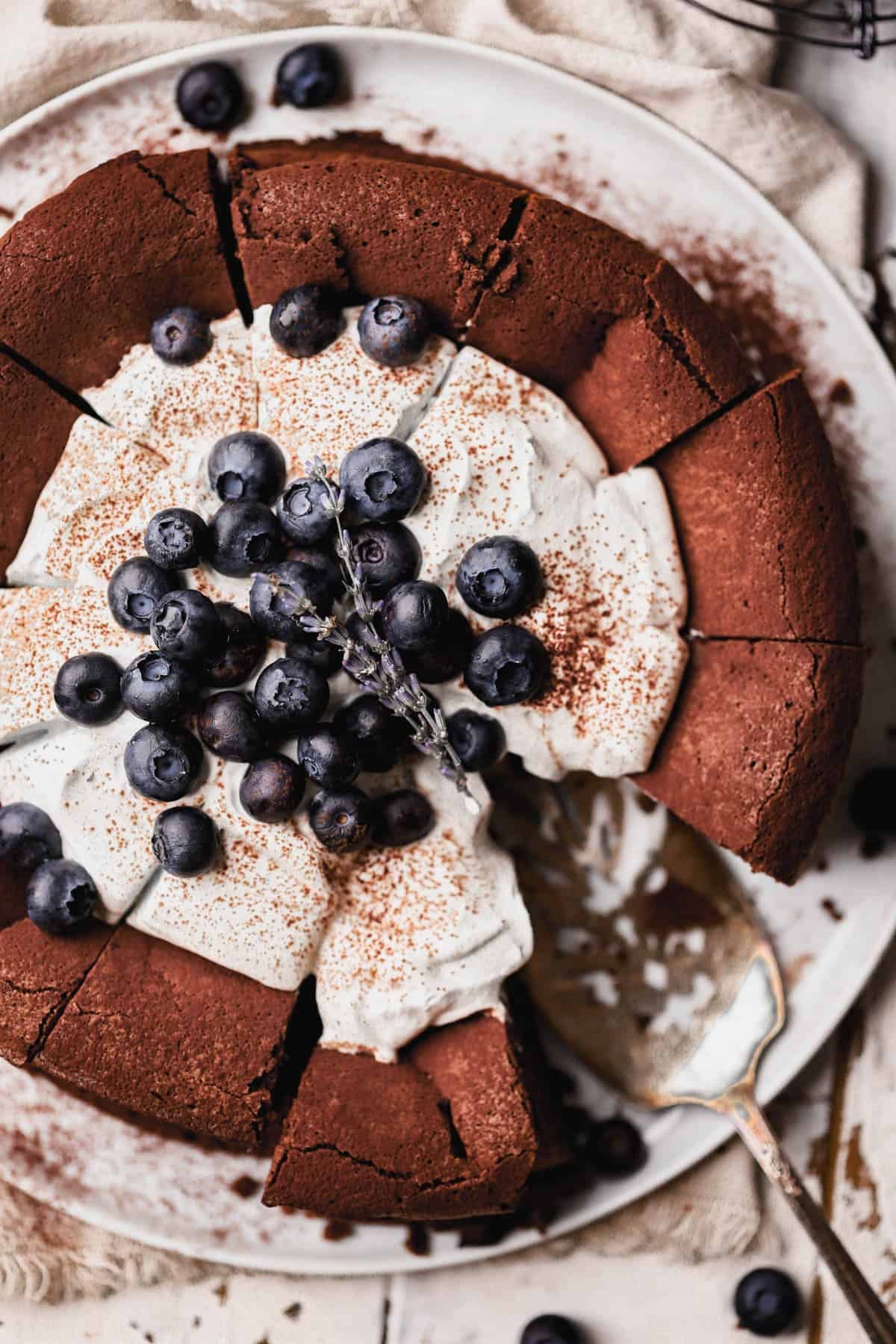 Flourless chocolate blueberry cake with homemade lavender infused whipped cream and fresh blueberries. 