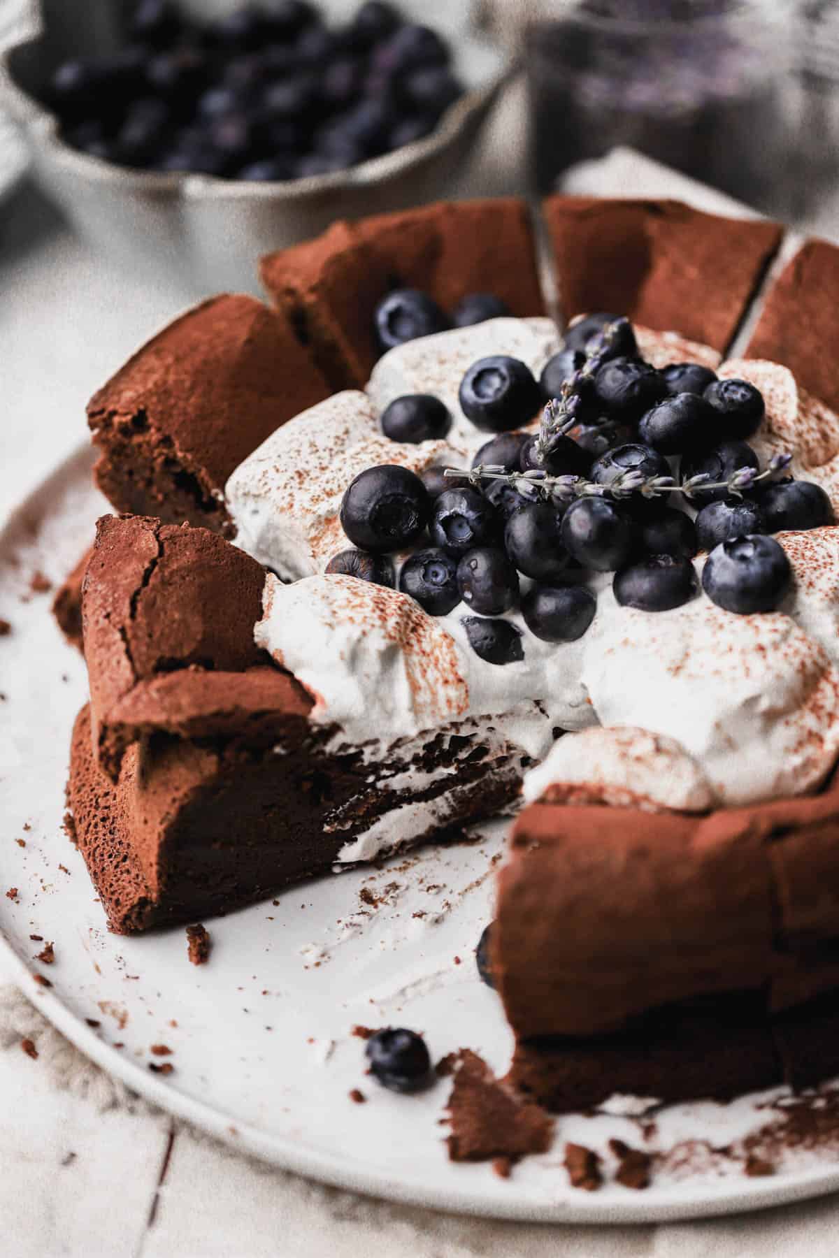 Flourless chocolate blueberry cake with lavender infused whipped cream and fresh blueberries. 