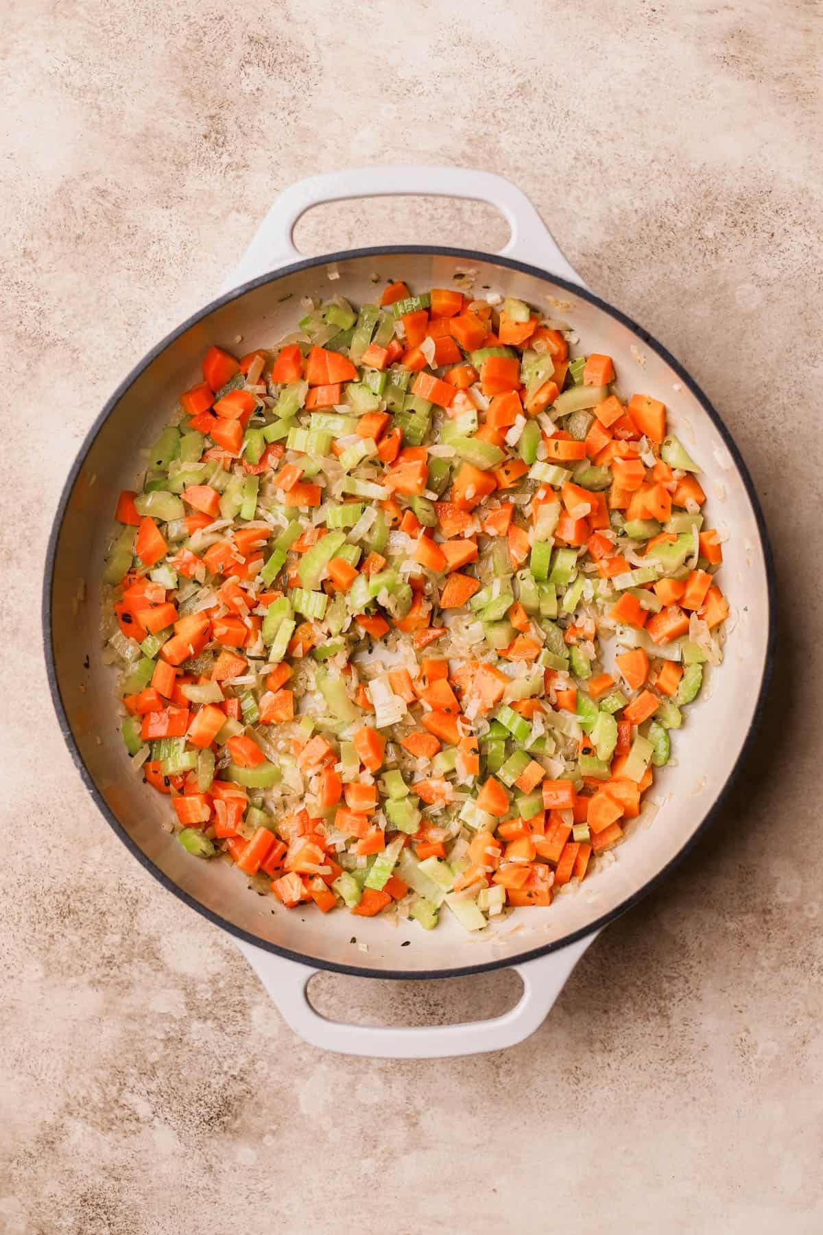 Butter, chopped carrots, onions, celery, fresh thyme, and fresh rosemary.