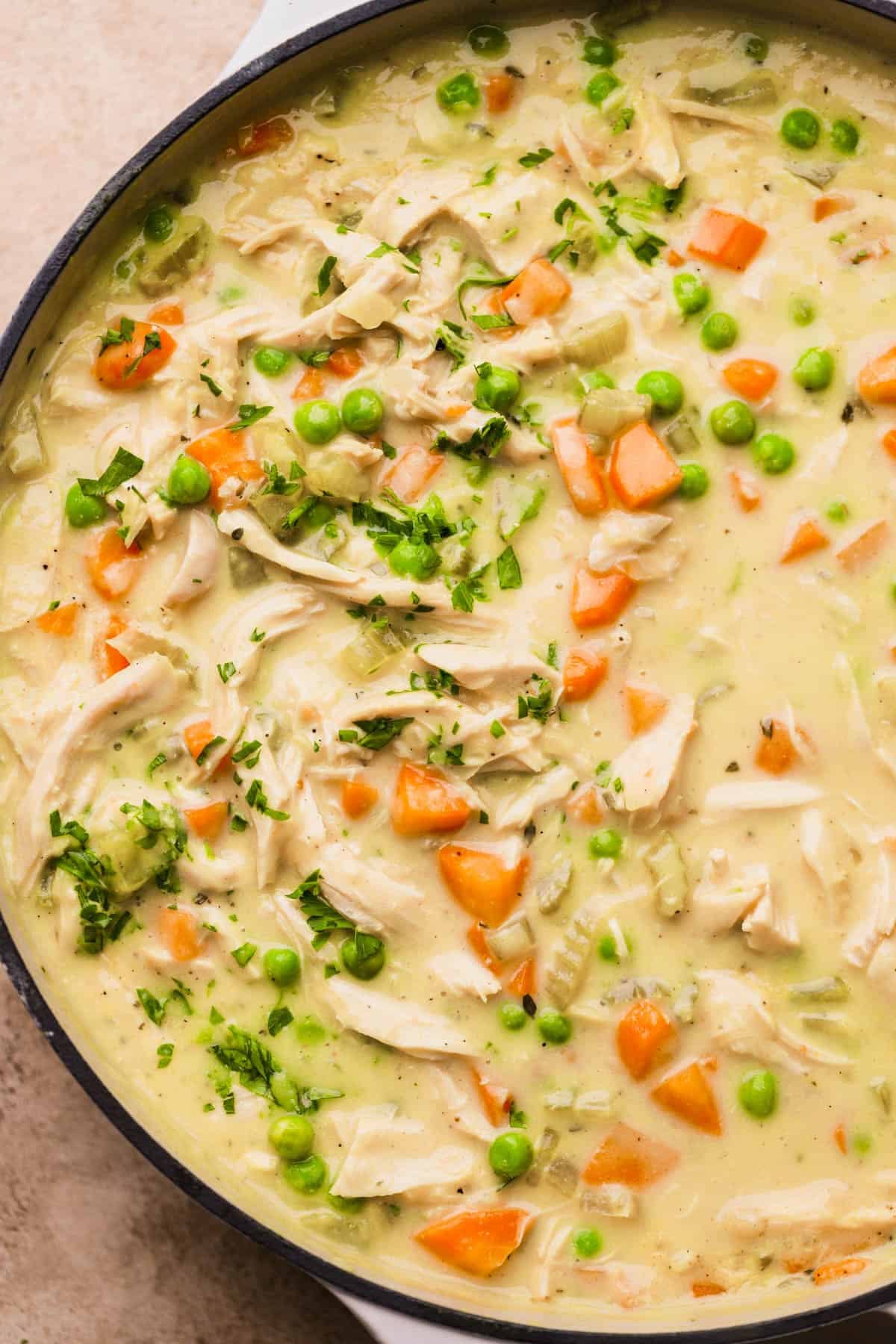 Deconstructed chicken pot pie with carrots, celery, onions, chicken broth, heavy cream, rotisserie chicken, and parsley.