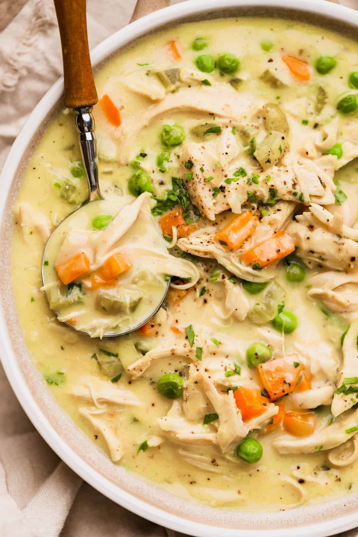 Deconstructed chicken pot pie with carrots, celery, onions, chicken broth, heavy cream, rotisserie chicken, and parsley.