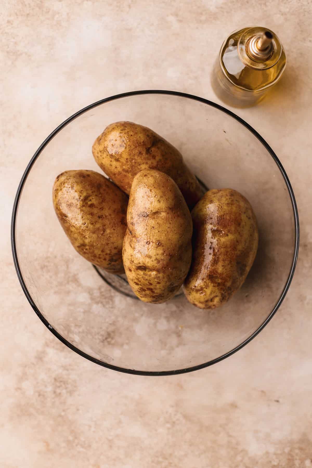 Russet potatoes coated in olive oil.