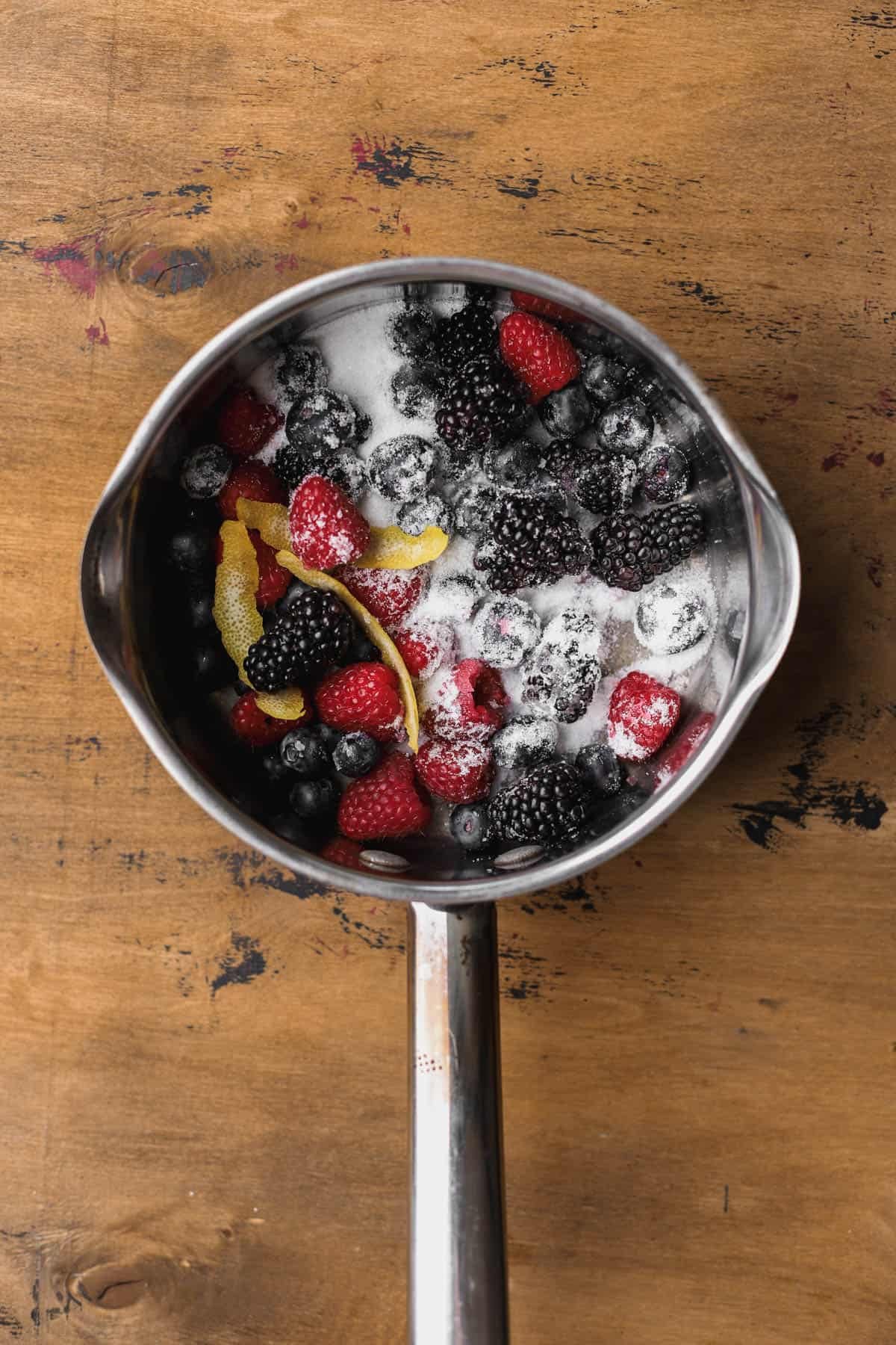 Raspberries, blackberries, blueberries, sugar, lemon zest and lemon juice. 