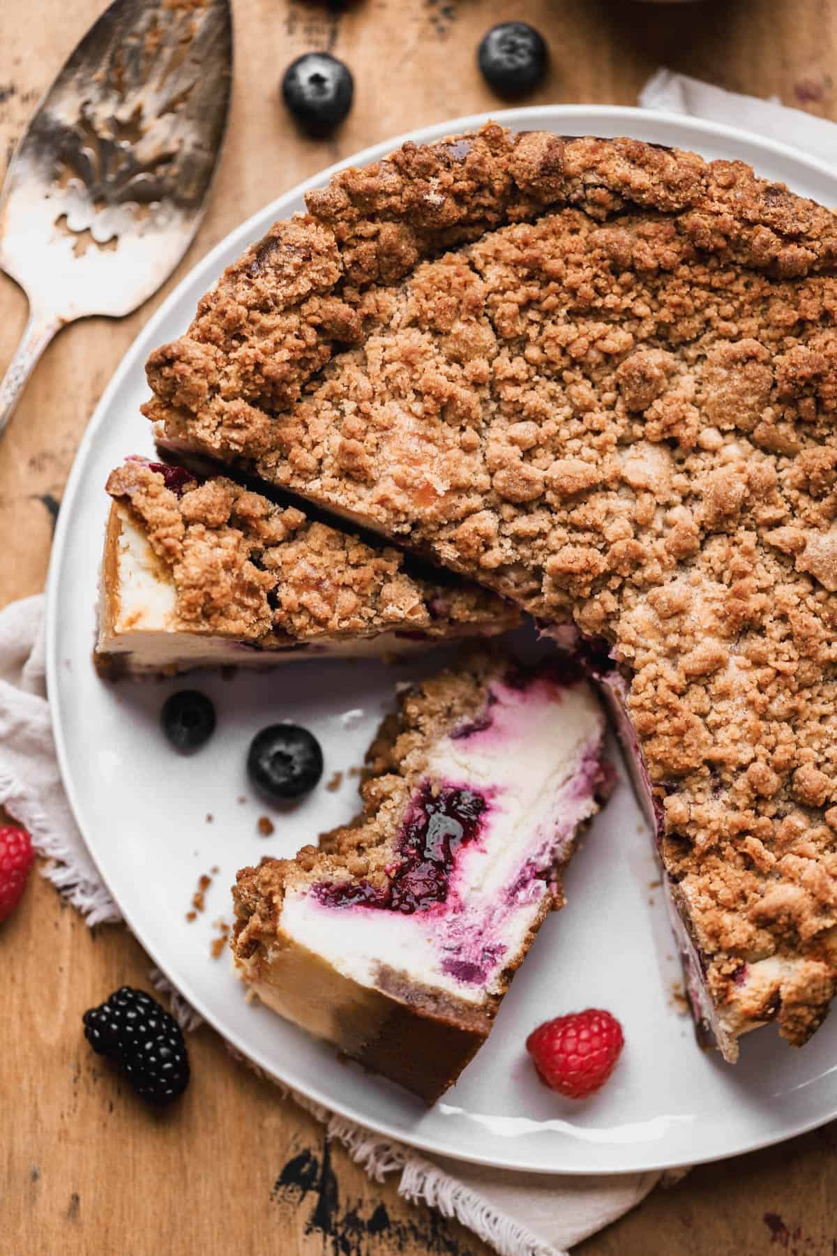 Berry crumble cheesecake with mixed berry compote, graham cracker crust and cinnamon streusel topping. 