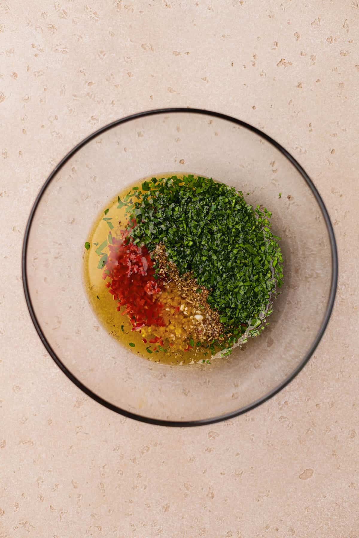 Chopped parsley, fresno pepper, garlic, dried oregano, salt, pepper, olive oil, and red wine vinegar. 