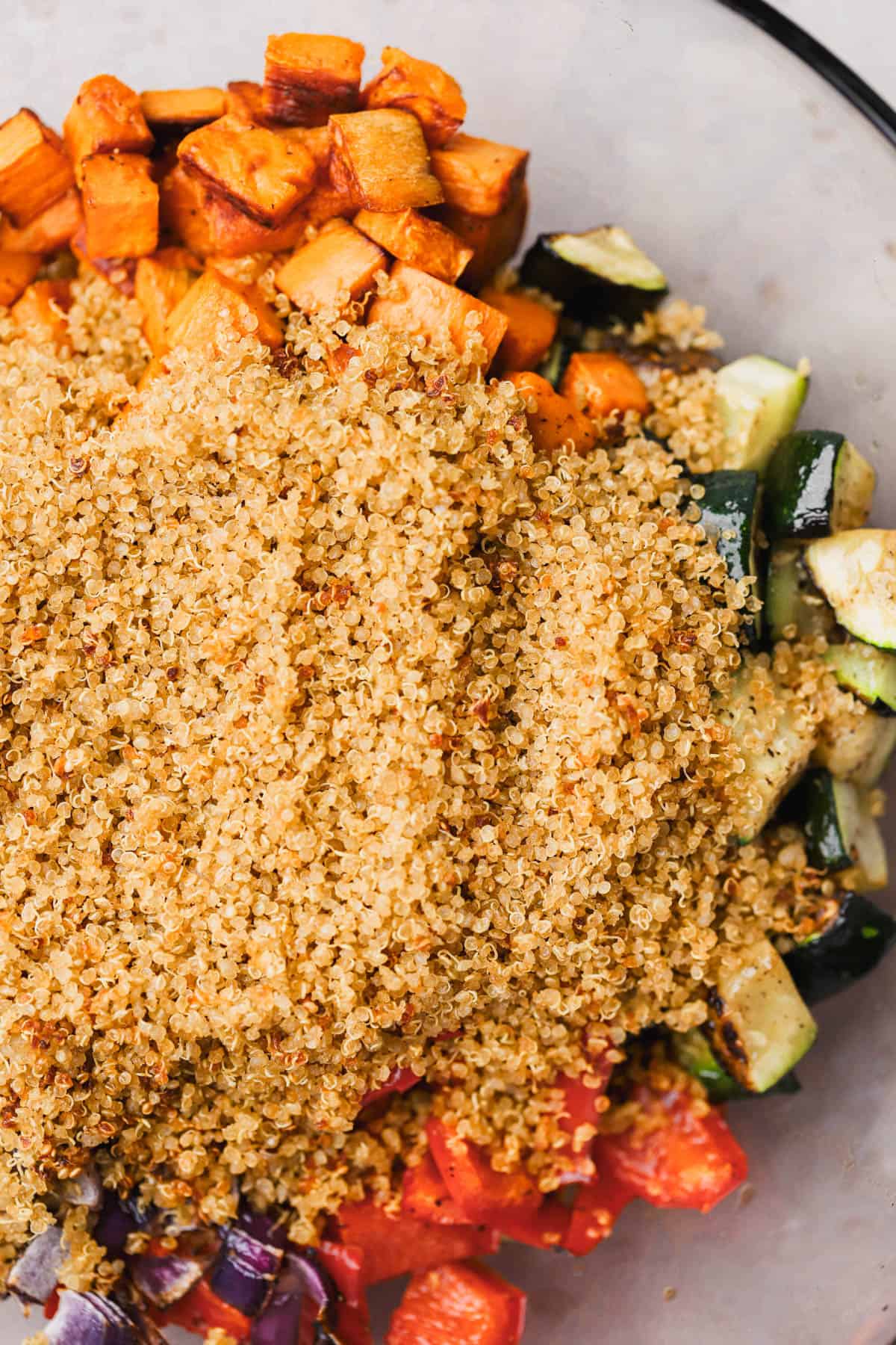 Crispy quinoa, roasted zucchini, red bell pepper, red onion, and sweet potato. 