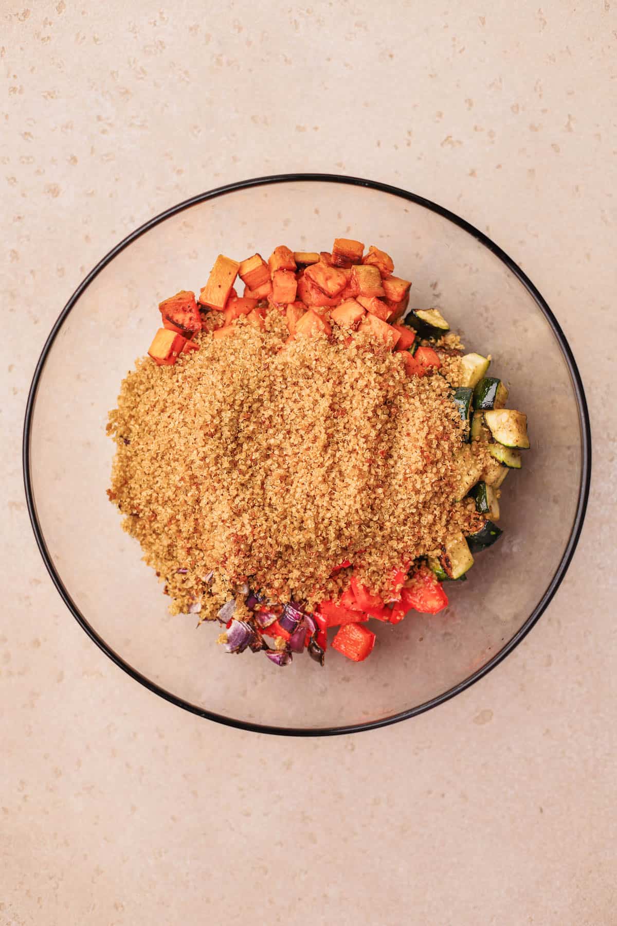 Quinoa Roasted Vegetable Salad with zucchini, sweet potato, red bell pepper, red onions and crispy quinoa.  