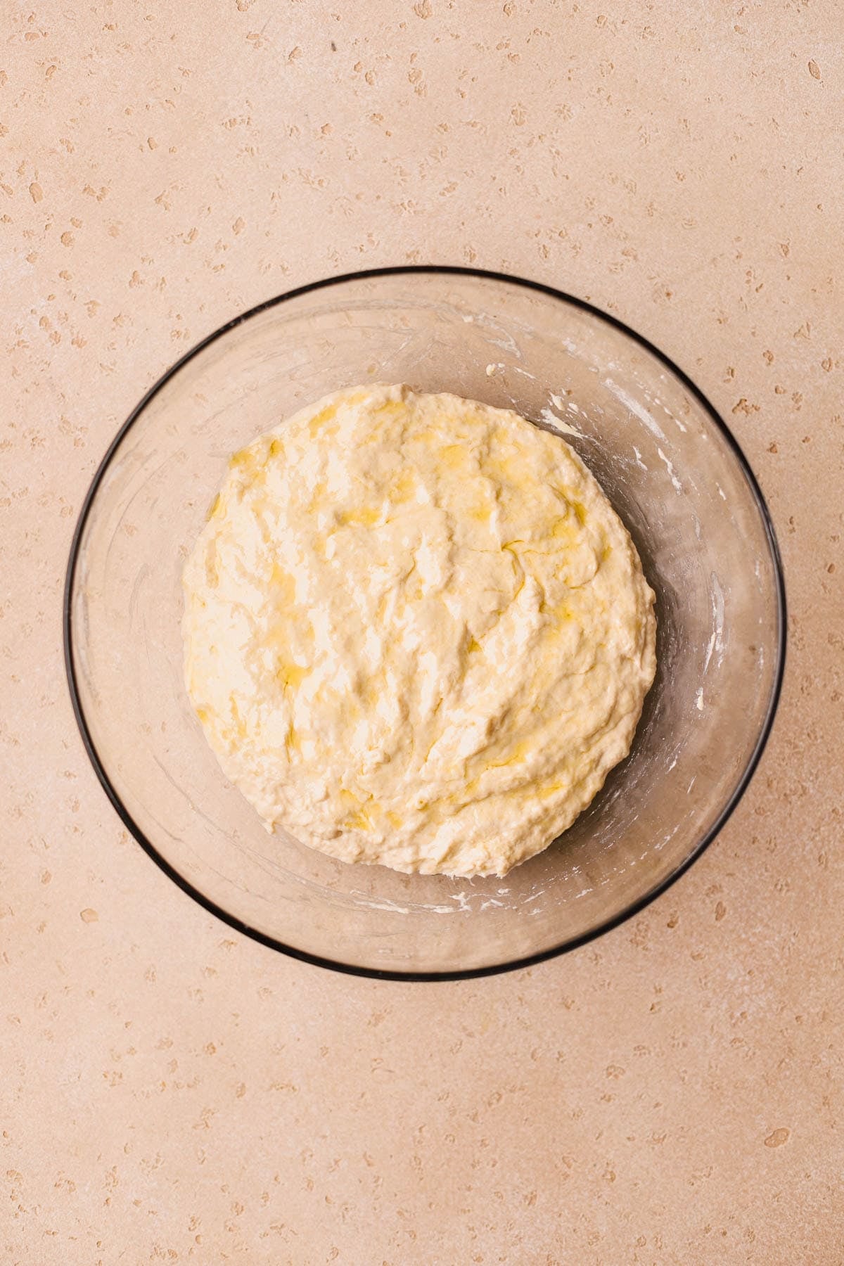 Focaccia dough topped with olive oil.