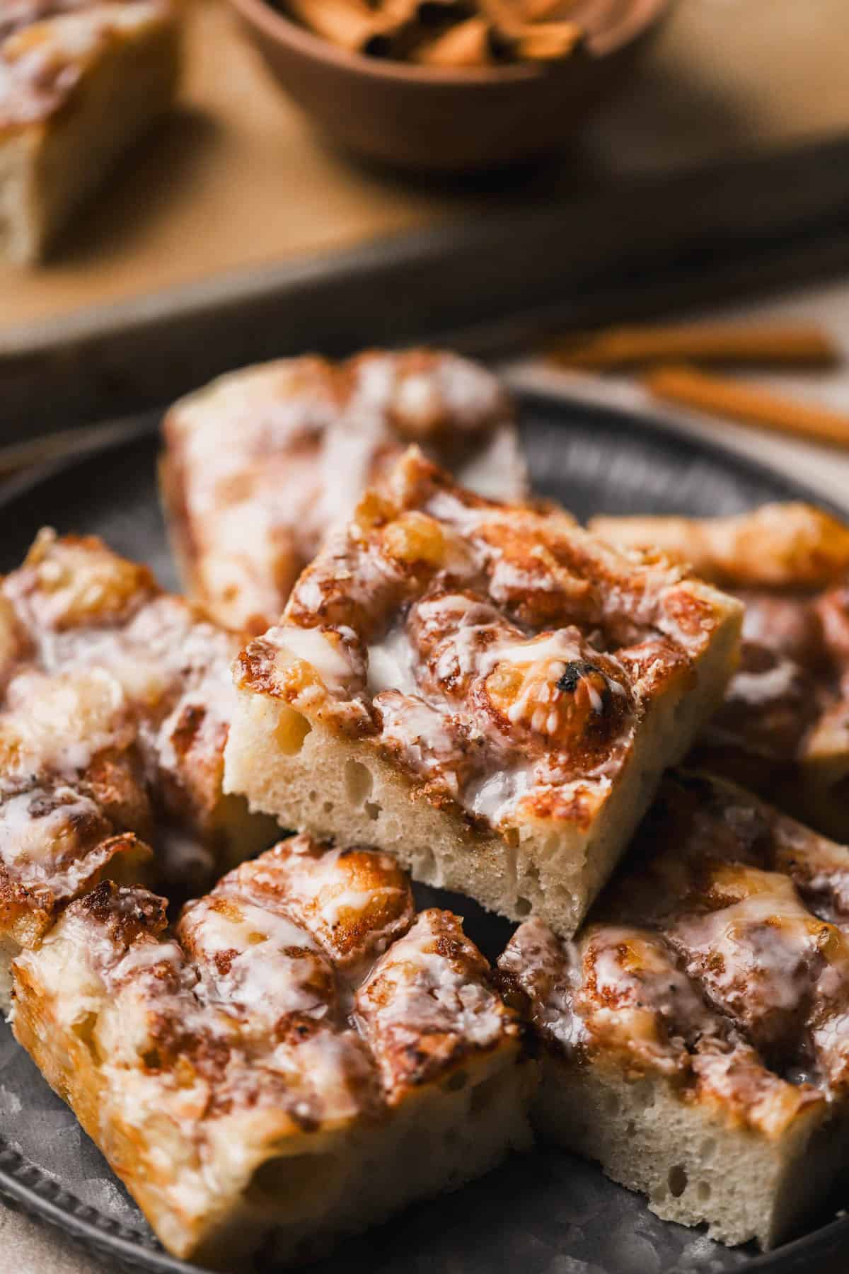 Cinnamon Focaccia is a yeast dough, made with brown butter and topped with cinnamon sugar and vanilla glaze.