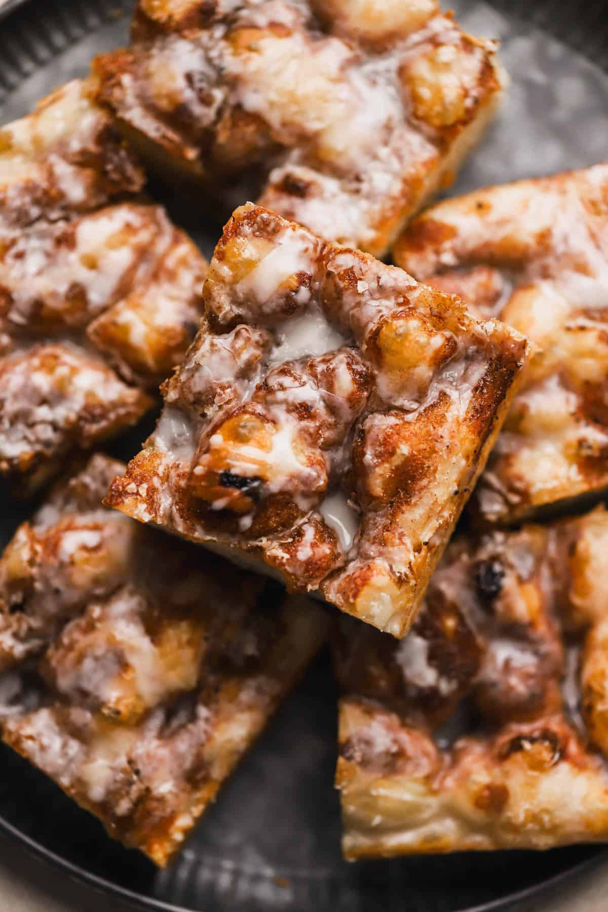 Cinnamon Focaccia is a yeast dough, made with brown butter and topped with cinnamon sugar and vanilla glaze.