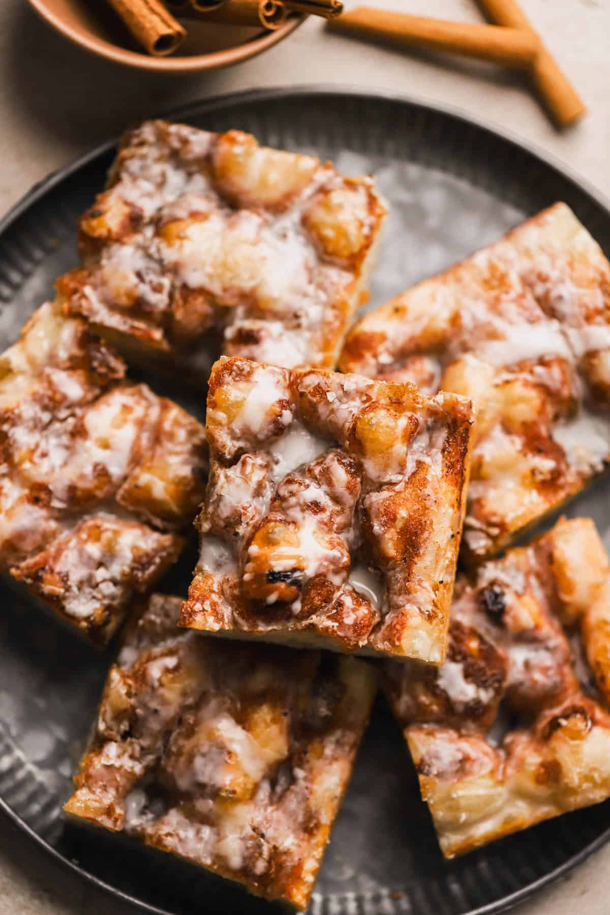 Cinnamon Focaccia is a yeast dough, made with brown butter and topped with cinnamon sugar and vanilla glaze.
