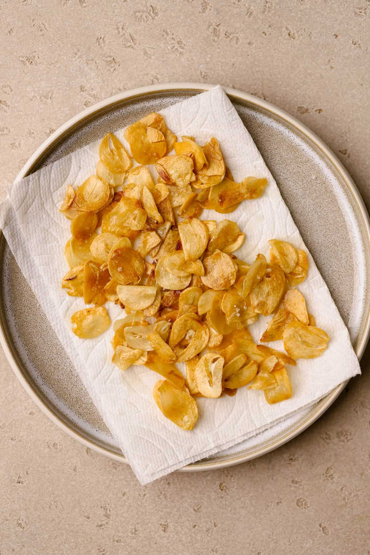 Toasted garlic cloves on paper towel to remove excess oil. 