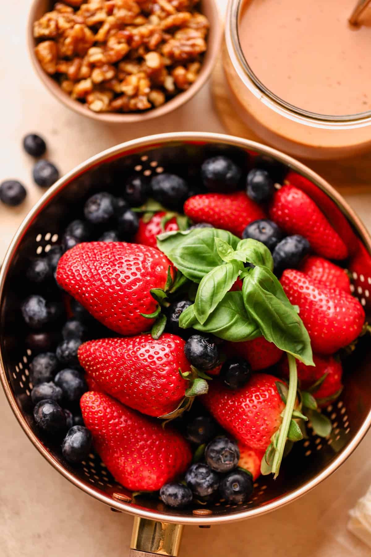 Strawberry basil balsamic dressing with candied walnuts, fresh strawberries, and blueberries.