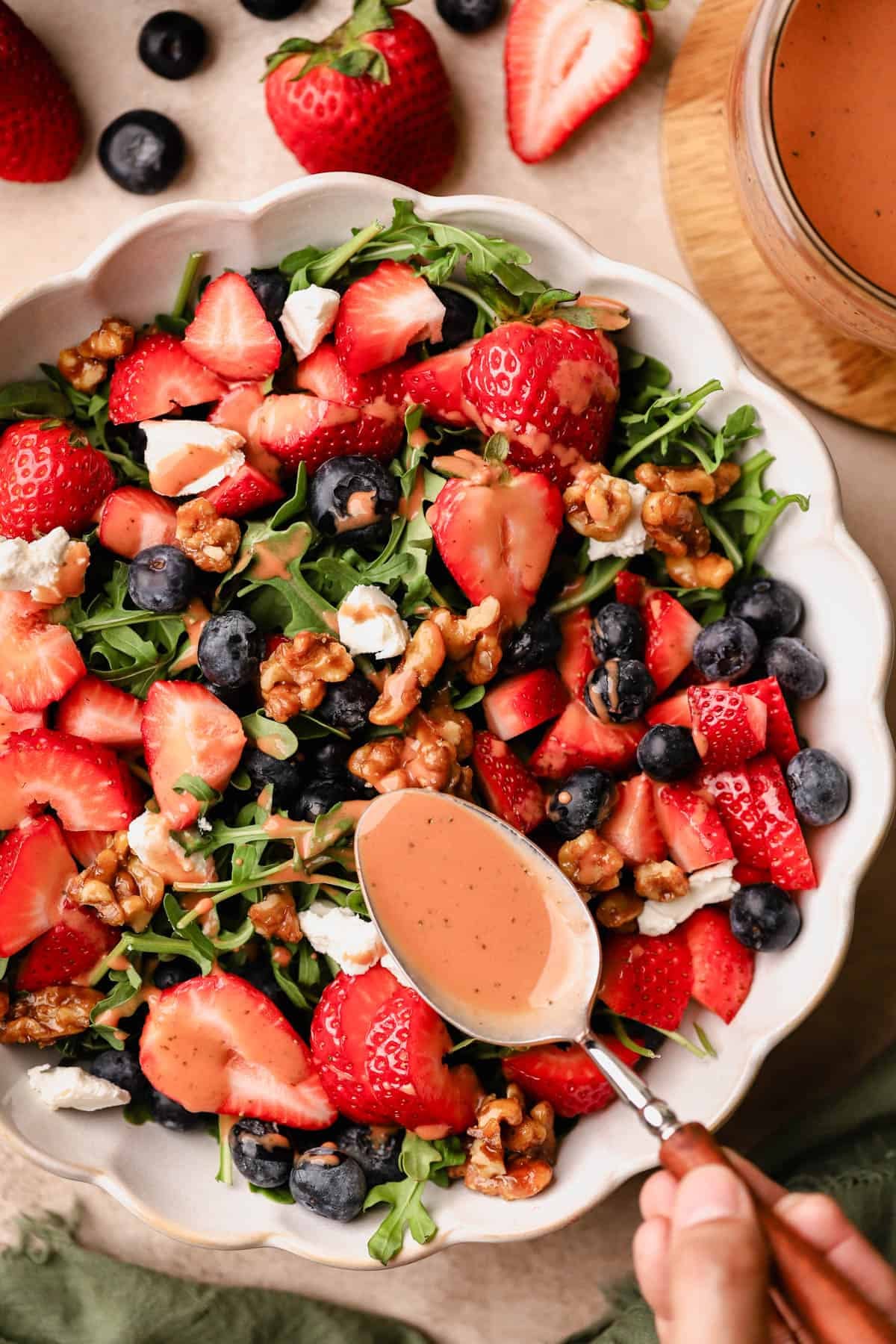 Blueberry and strawberry salad with strawberry basil balsamic dressing, goat cheese, and candied walnuts.