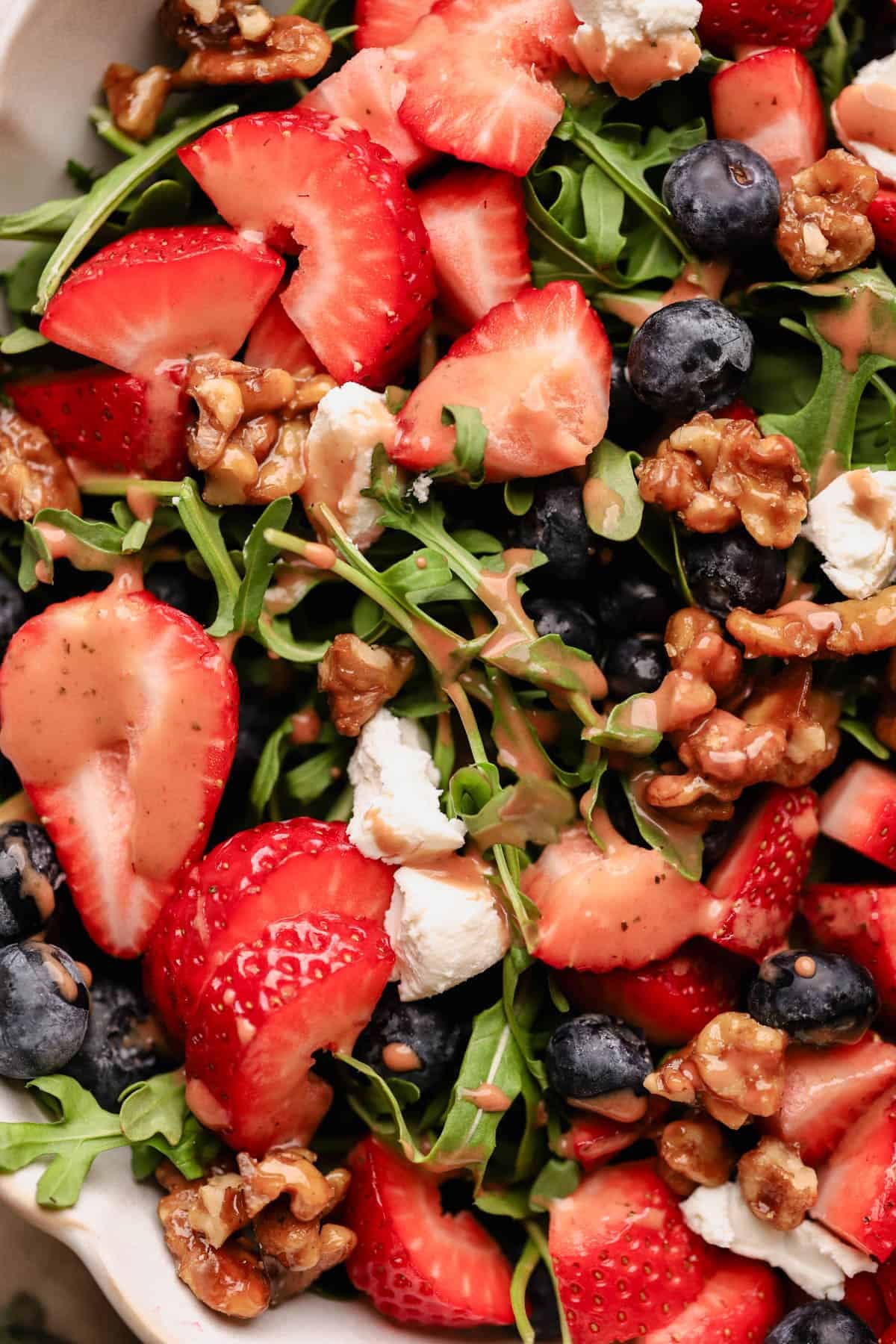 Blueberry and strawberry salad with strawberry basil balsamic dressing, goat cheese, and candied walnuts.