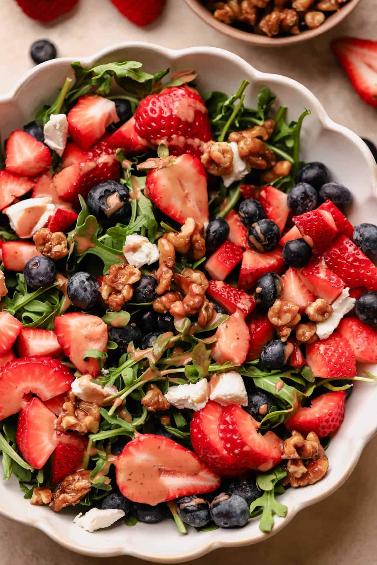 Blueberry and strawberry salad with strawberry basil balsamic dressing, goat cheese, and candied walnuts.