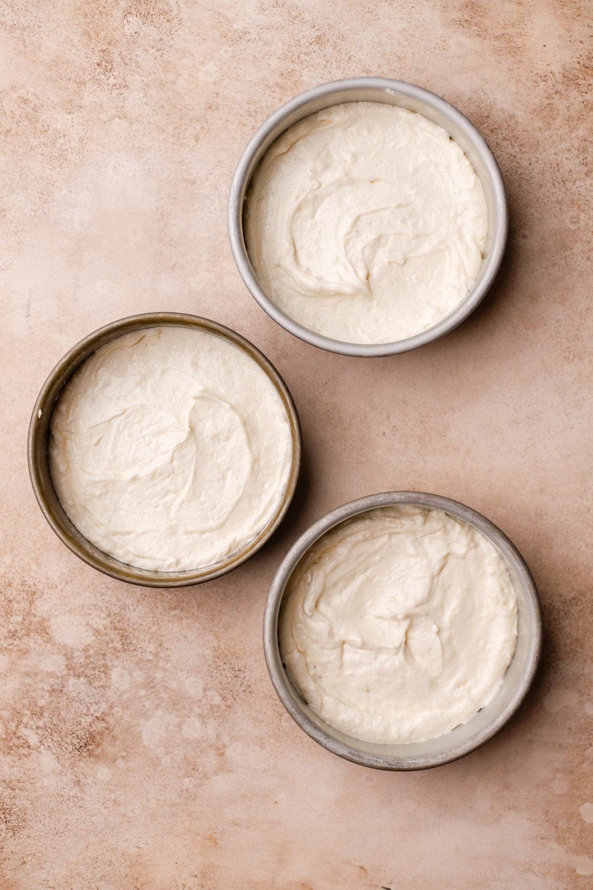 Coconut cake divided into three 6-inch cake pans.  