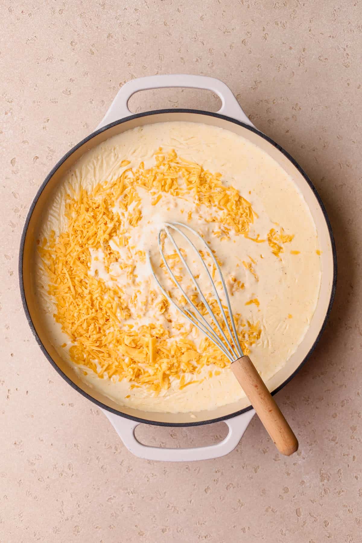 Melted butter, flour, half and half, whole milk, shredded cheddar cheese, paprika, salt and pepper. 