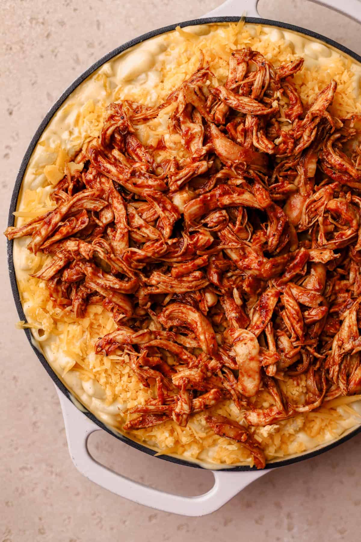 Mac and cheese topped with bbq chicken. 