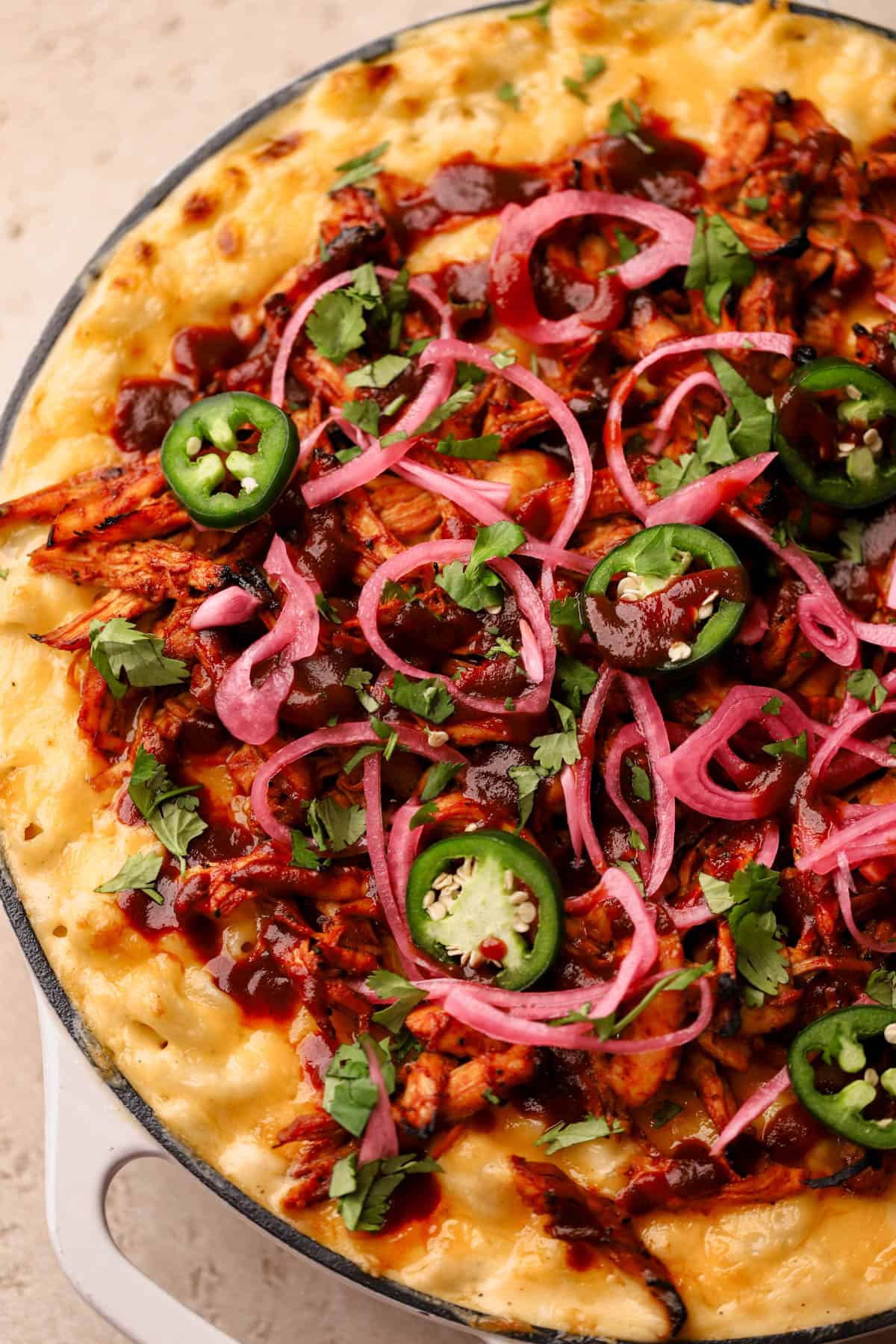 Baked Cheddar cheese with bbq chicken, pickled onions, cilantro, and jalapeno peppers. 