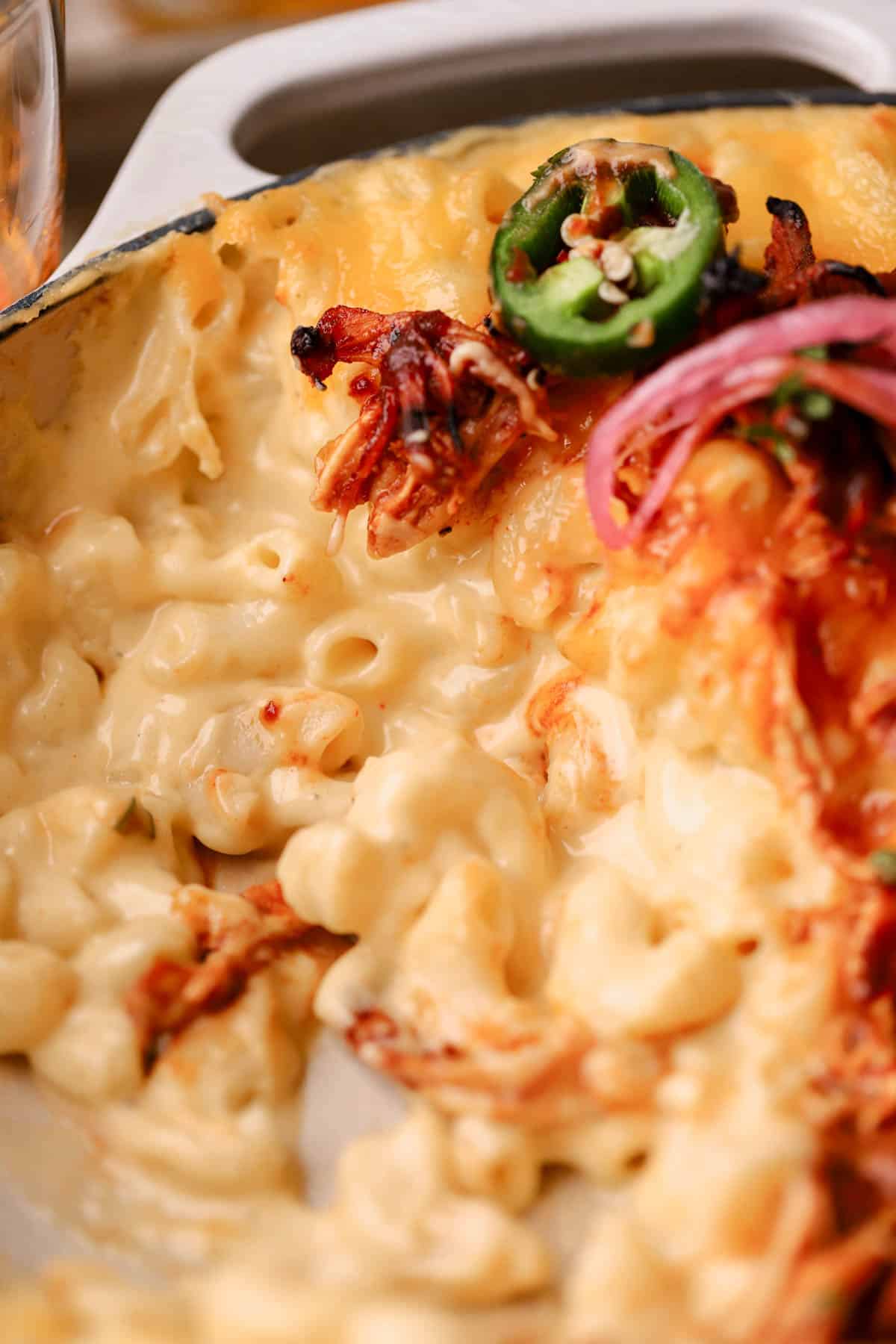 Creamy mac and cheese with bbq chicken, pickled onions and jalapeno peppers.