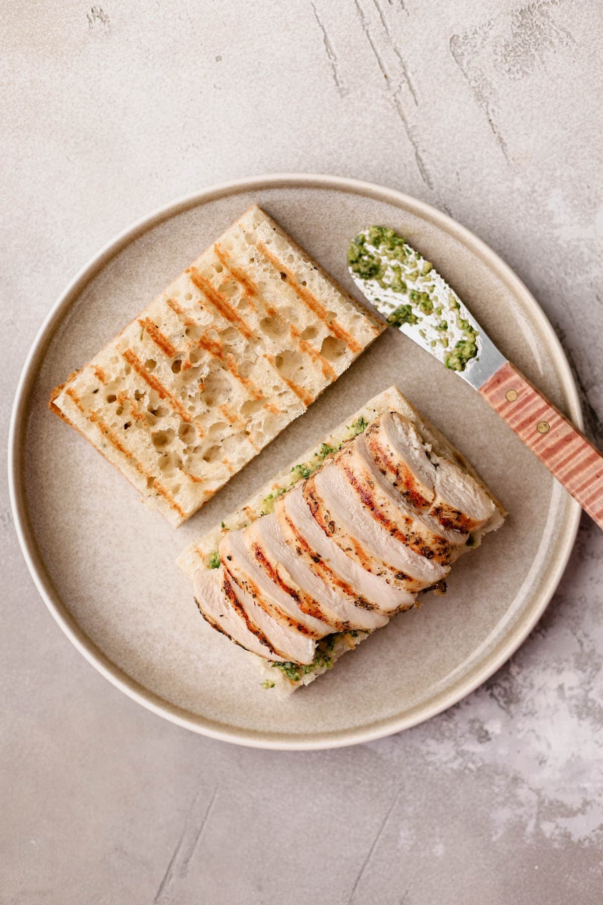 Grilled focaccia with homemade basil spread and grilled chicken.