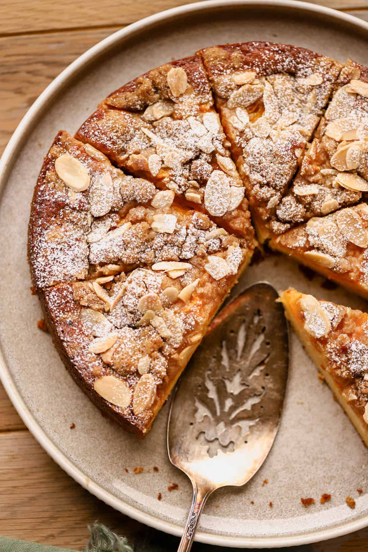 Almond apricot cake made with almond paste, and topped with fresh apricots, sliced almonds and cinnamon crumble.