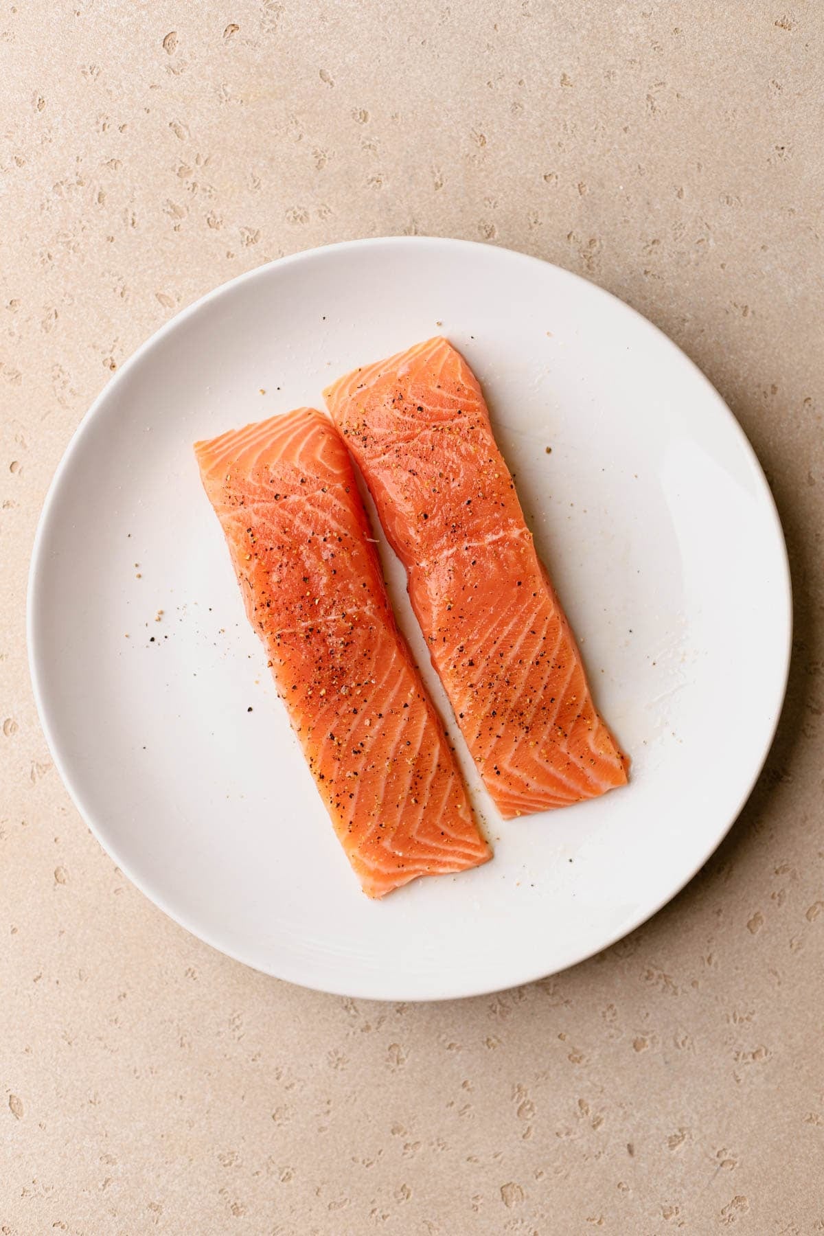 Salmon fillets seasoned with salt and pepper. 