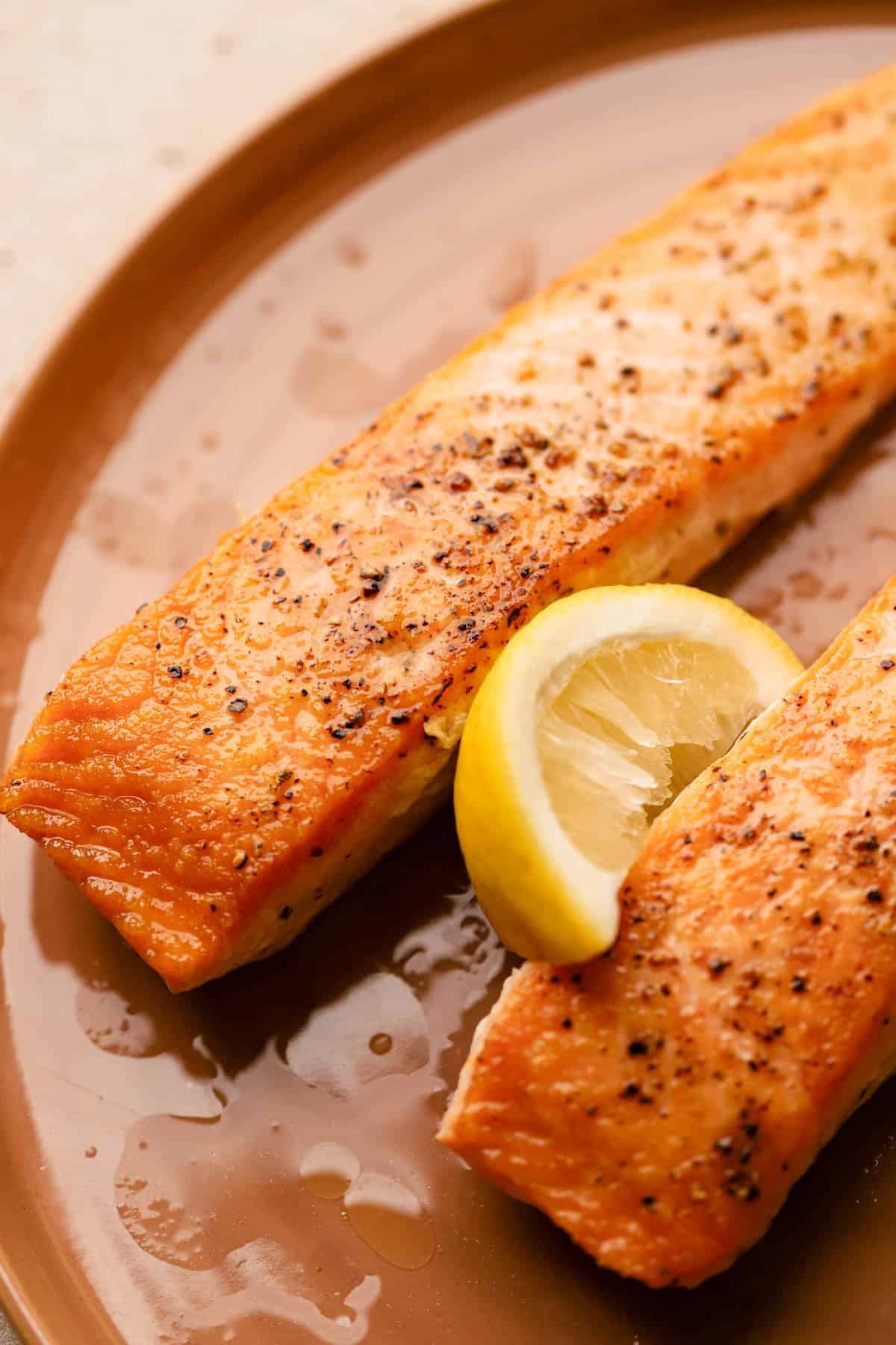 Pan-seared salmon fillets with fresh lemon juice. 