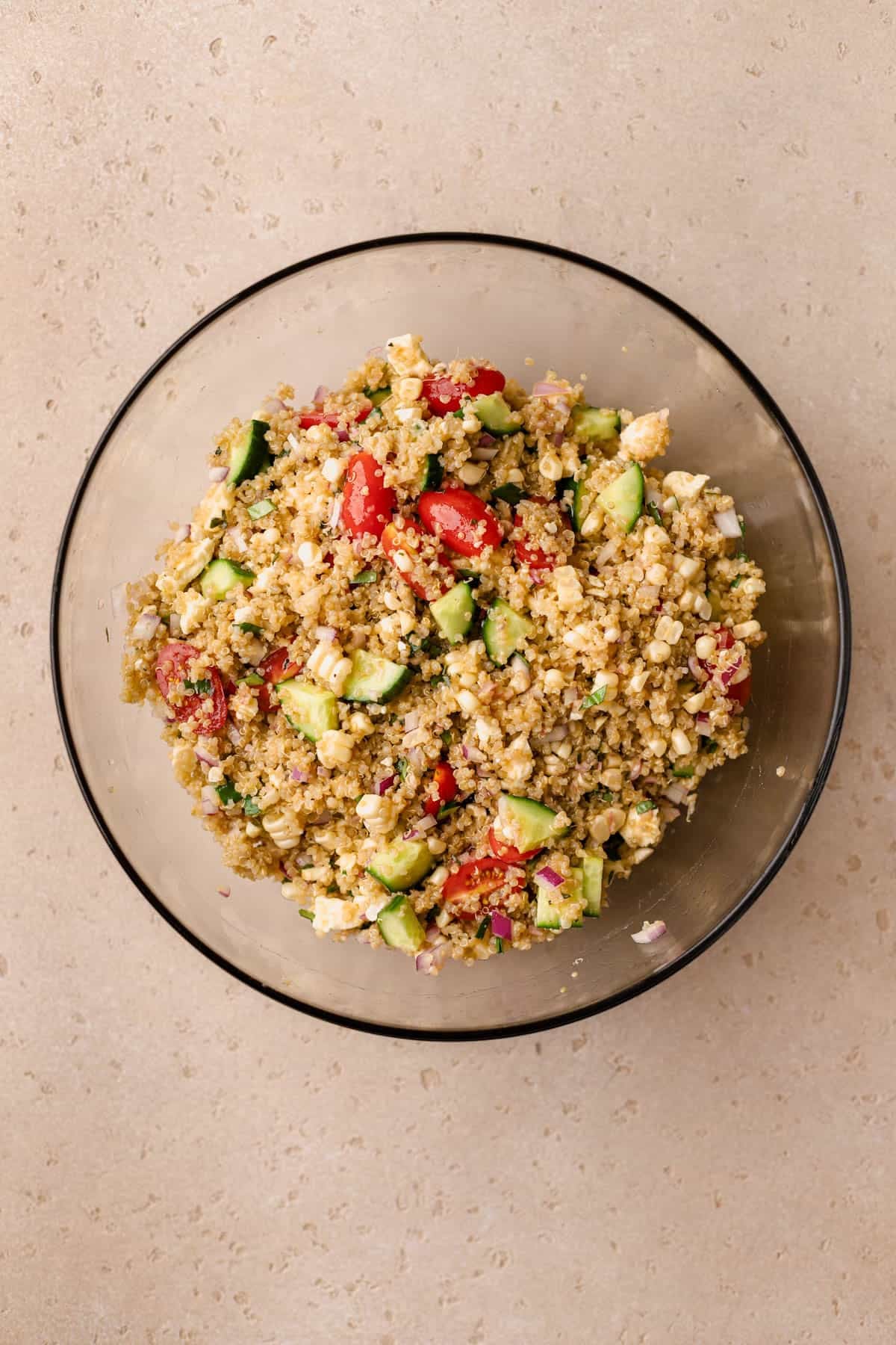 Quinoa salad made with cucumbers, feta, cherry tomatoes, radishes, red onions, basil, avocado, and tarragon vinaigrette. 
