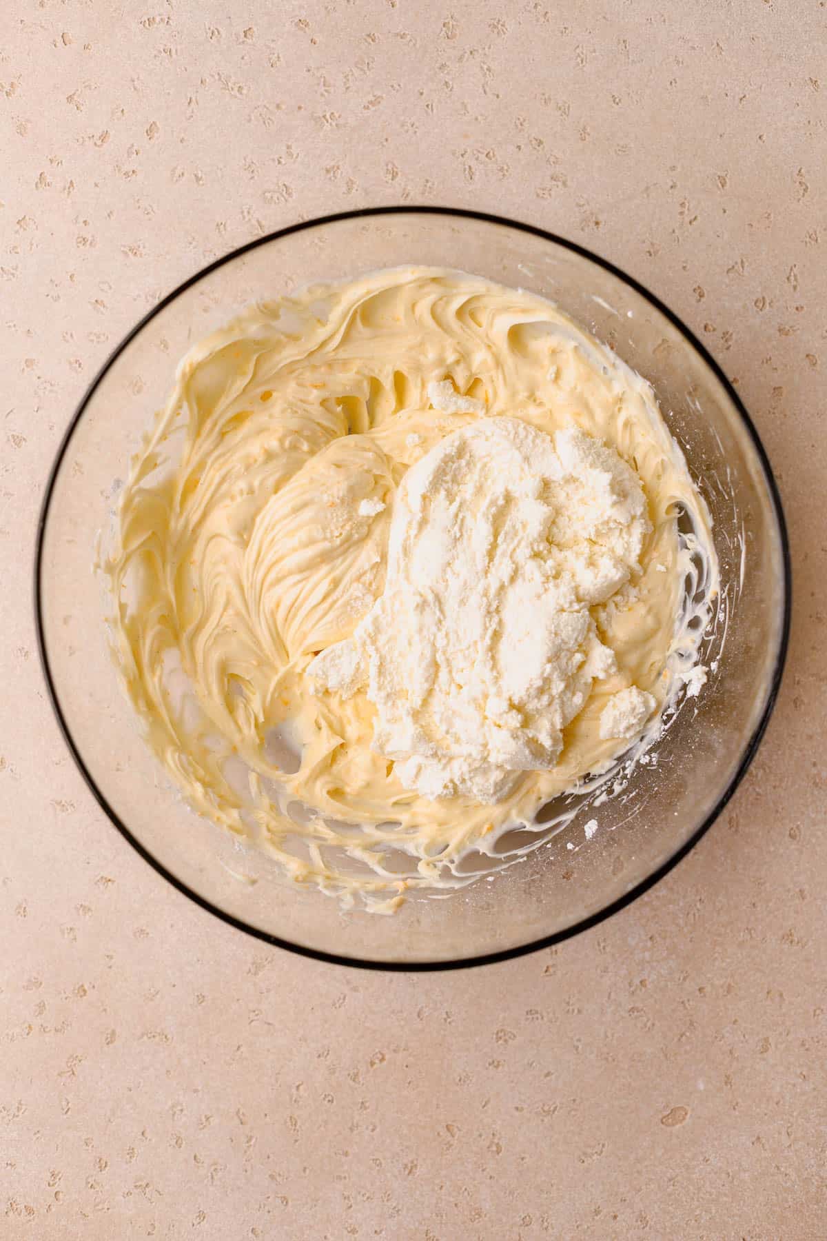 Softened cream cheese, drained ricotta cheese, powdered sugar, orange zest, and vanilla bean paste,  