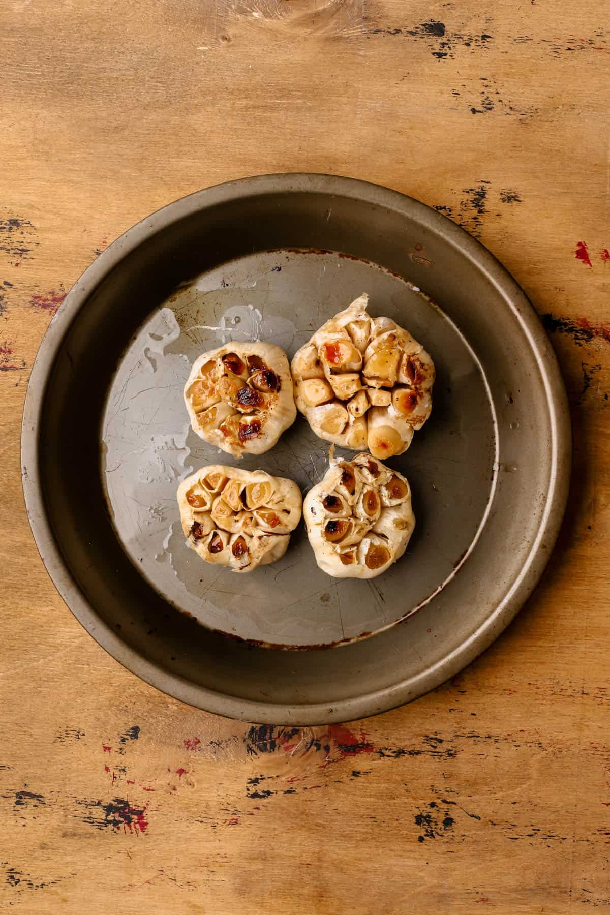 Roasted garlic bulbs with olive oil, salt, and pepper. 