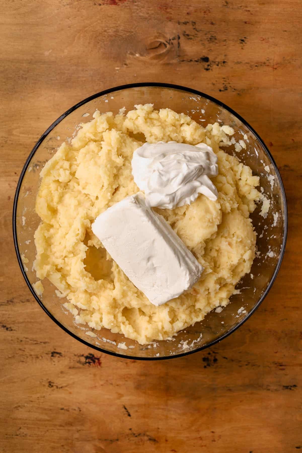 Gold potatoes, butter, roasted garlic cloves, sour cream, and cream cheese. 