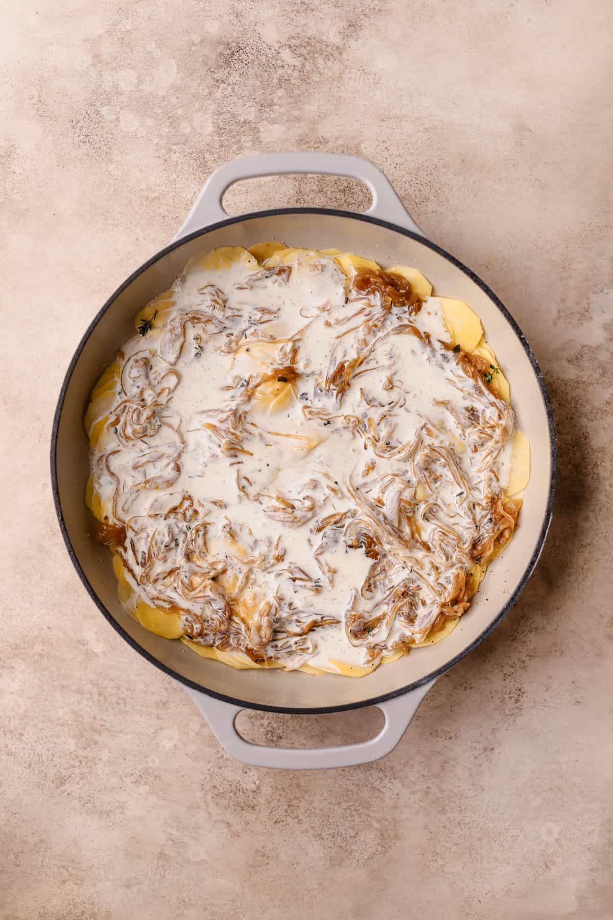 Sliced gold potatoes, caramelized onions, fresh thyme, heavy cream, and milk.