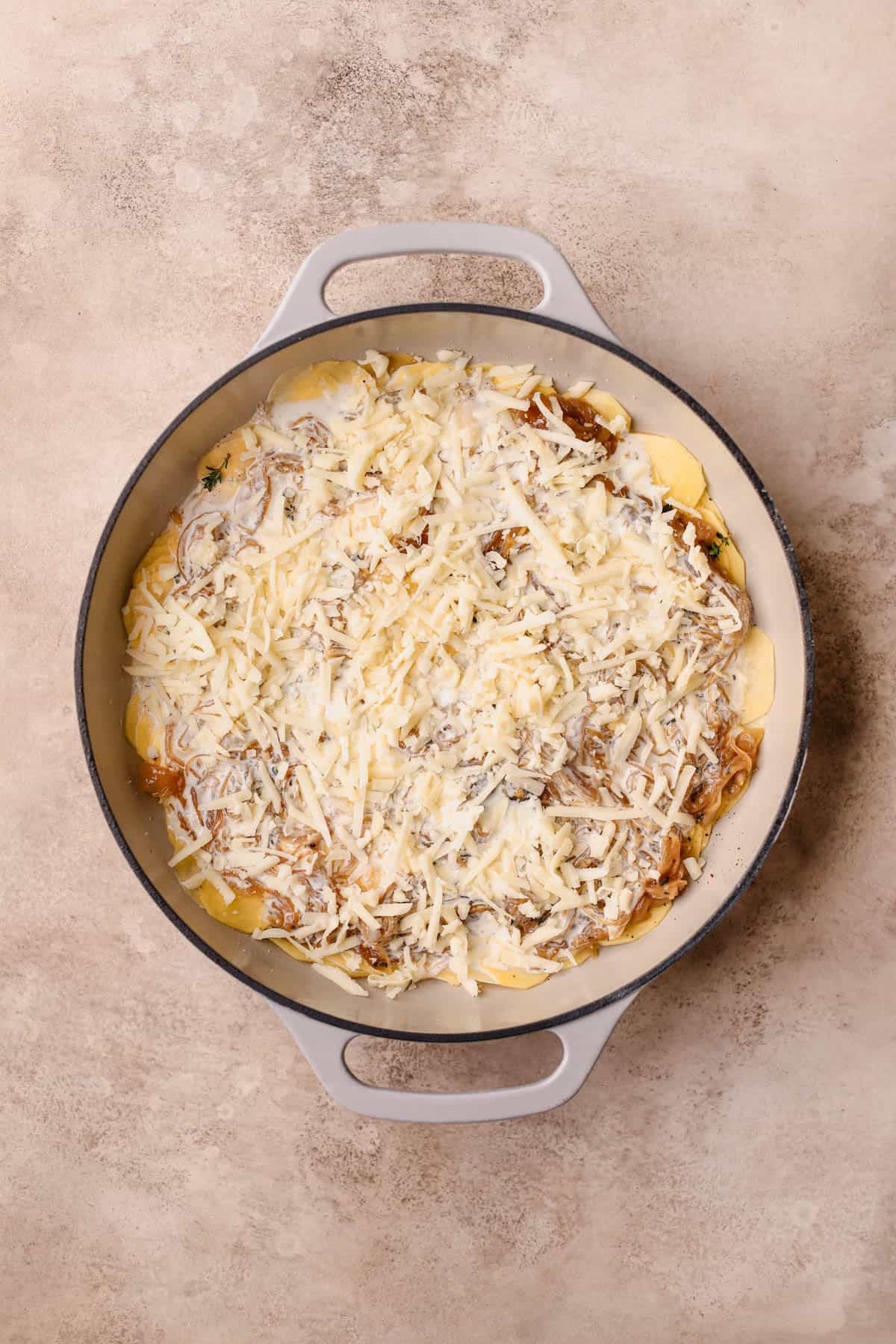 Sliced gold potatoes, caramelized onions, fresh thyme, heavy cream, milk, Gruyere and white cheddar.