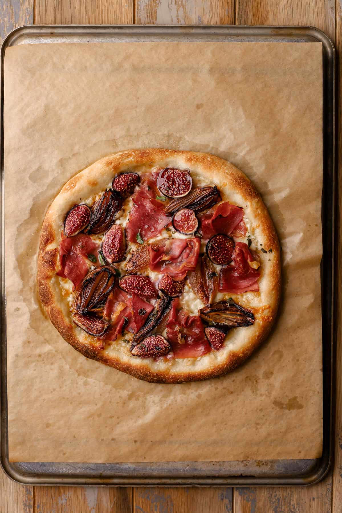 Fig Prosciutto Pizza with caramelized shallots, fontina cheese, and hot honey.