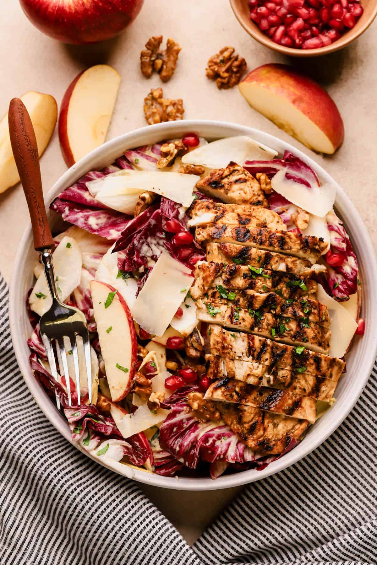 Balsamic grilled chicken salad with radicchio, endive, apples, pomegranates, walnuts, parmesan and maple-dijon dressing. 