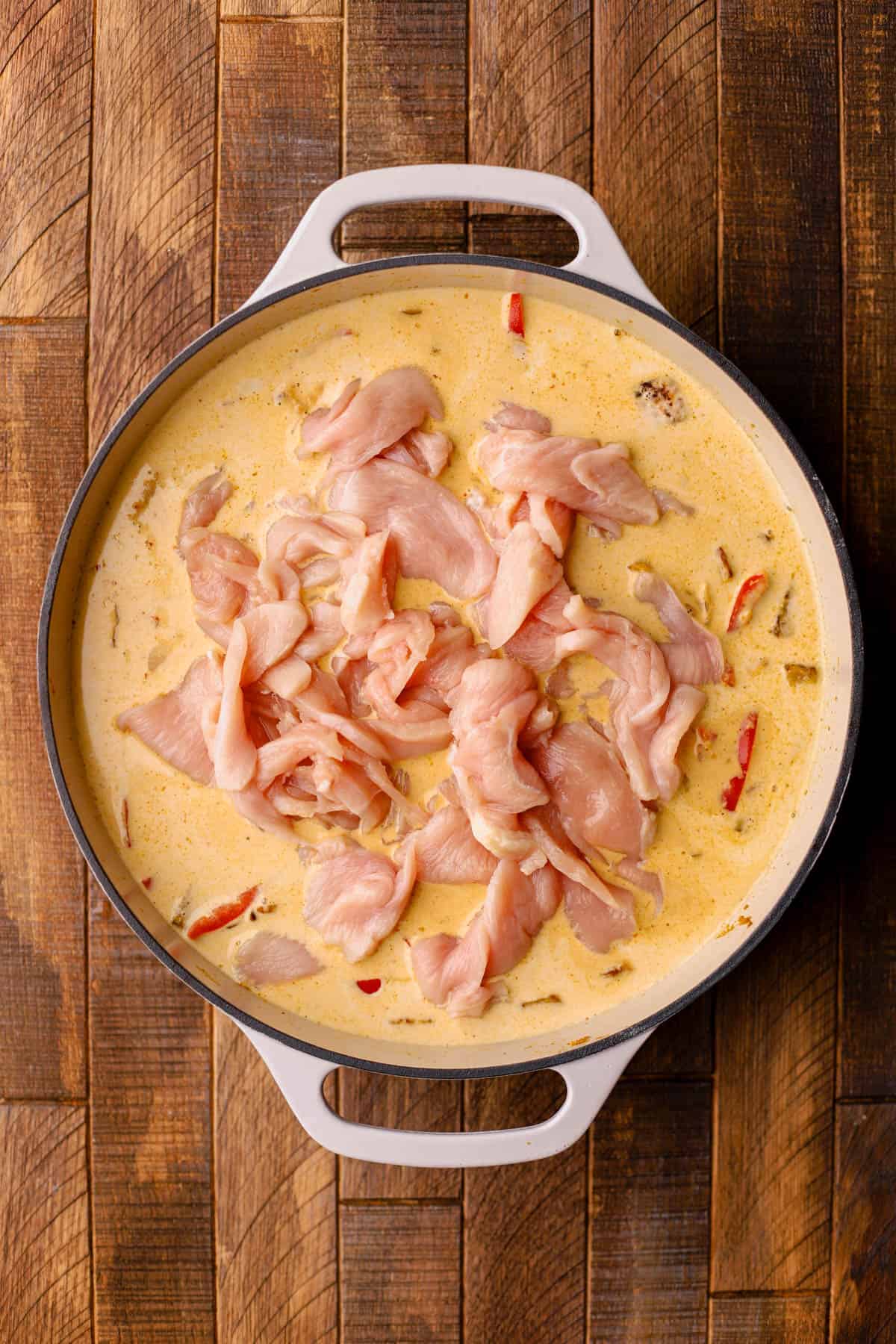 Sauteed shallots, garlic, ginger, yellow curry paste, pumpkin puree, red bell peppers, pan seared butternut squash, chicken stock, coconut milk, and sliced chicken. 