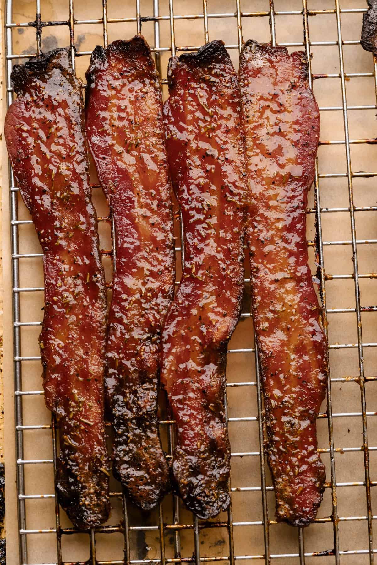 Candied bacon with thick-cut bacon, brown sugar, coarse black pepper, paprika, and fresh rosemary.