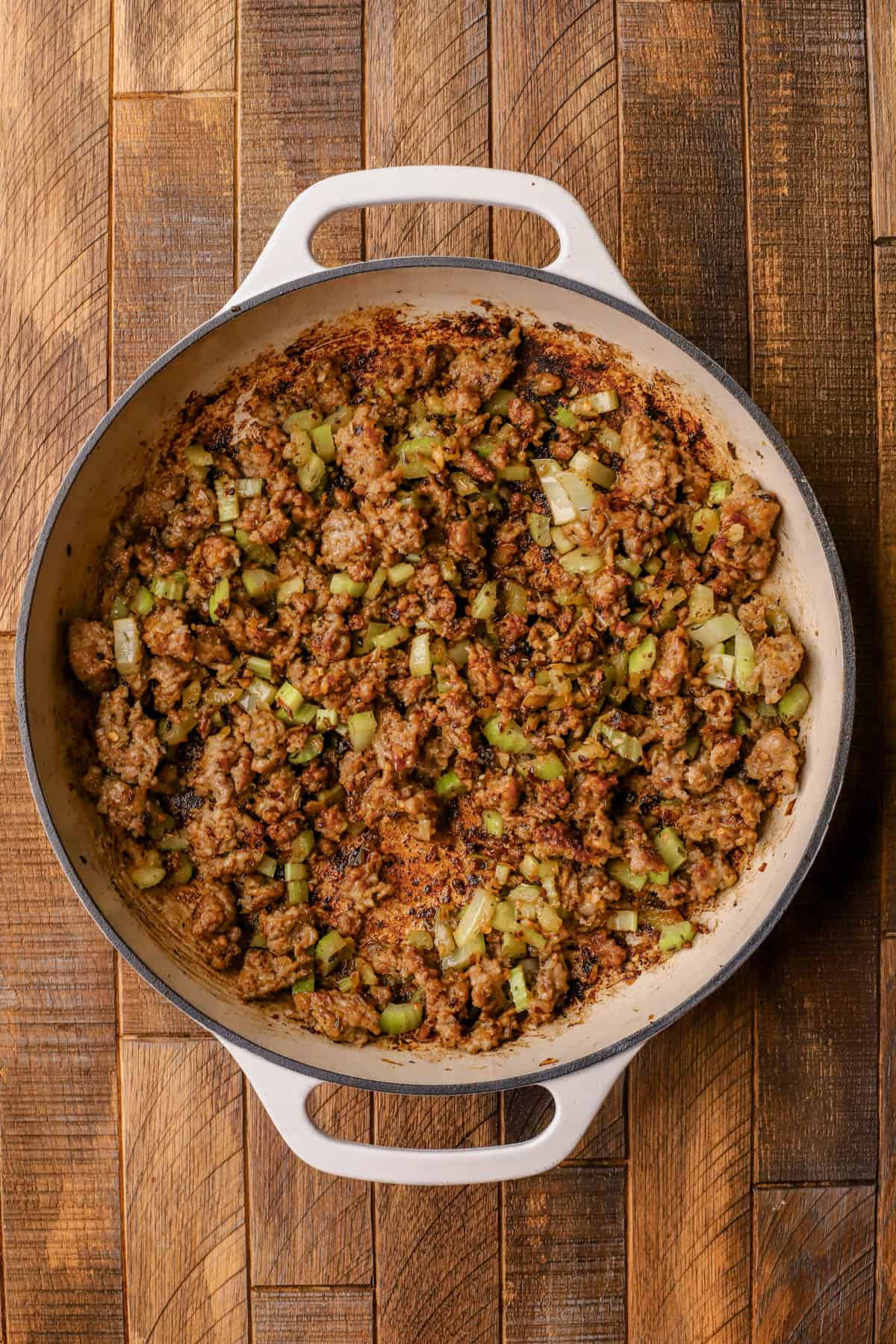 Browned Italian sausage, olive oil, yellow onions, celery, garlic, red pepper flakes, and Italian seasoning.