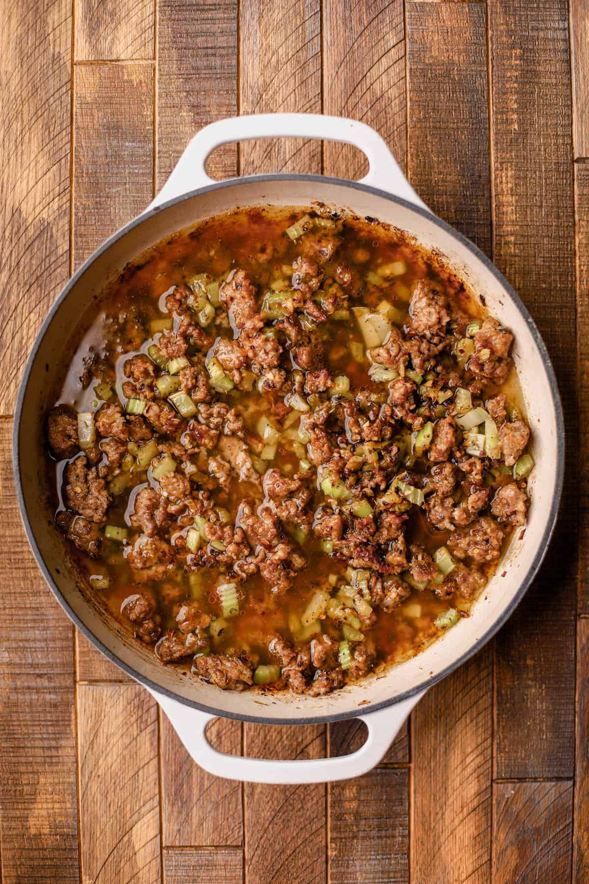 Browned Italian sausage, olive oil, yellow onions, celery, garlic, red pepper flakes, Italian seasoning, and chicken broth.