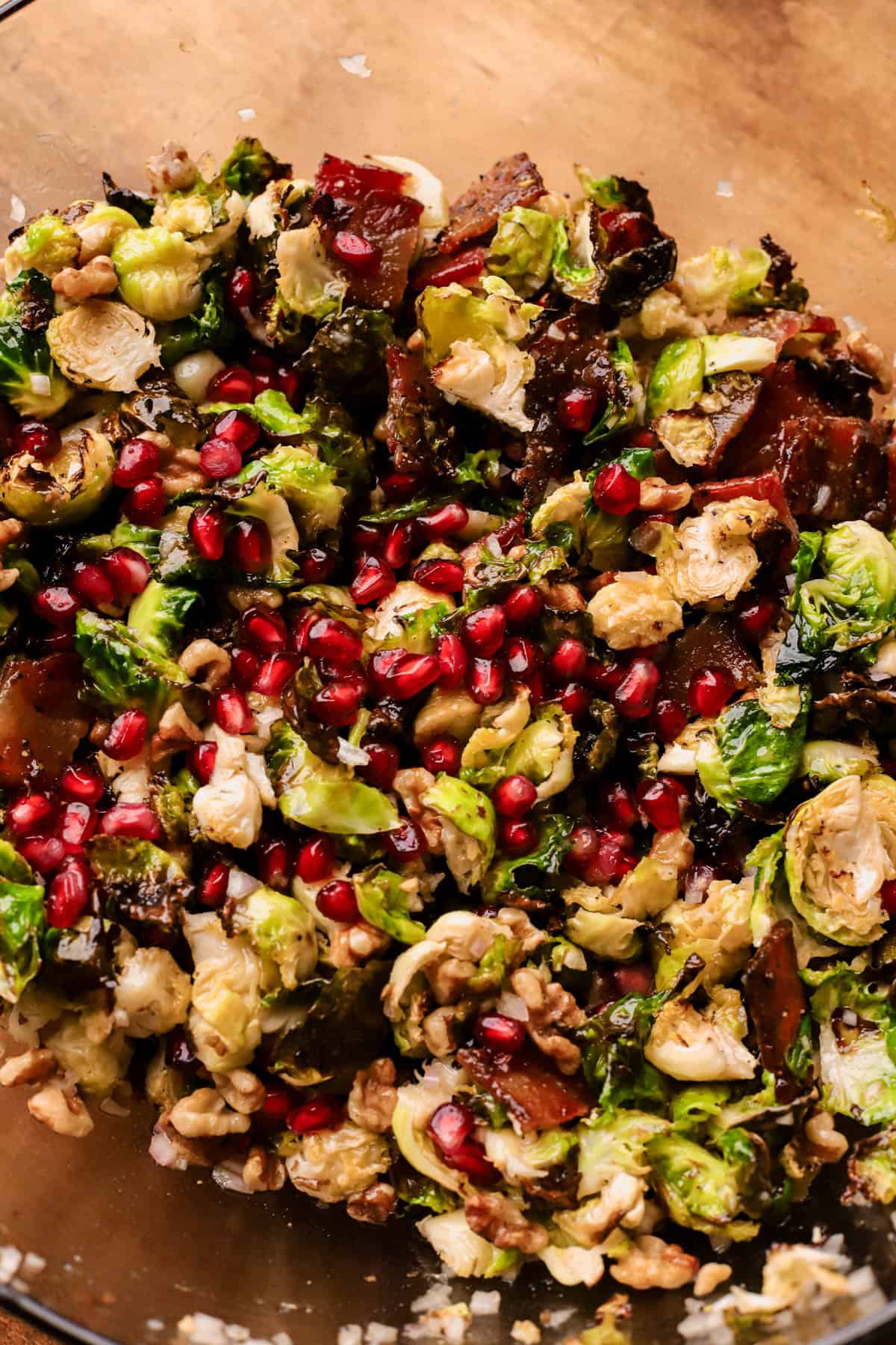 Roasted Brussels sprouts with candied bacon, pomegranate seeds, and crunchy walnuts, all tossed in a apple cider vinaigrette. 