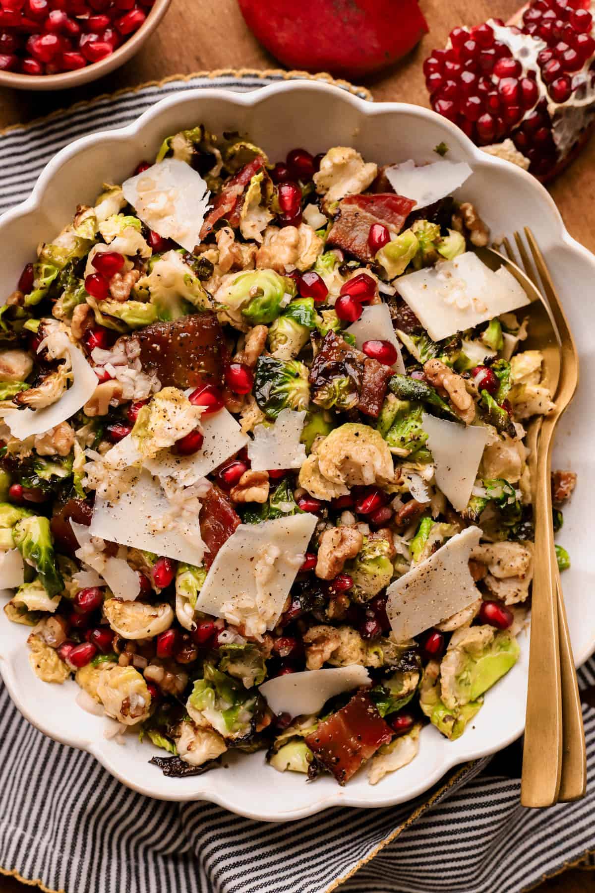 Warm Brussels sprouts salad with candied bacon, pomegranate seeds, and crunchy walnuts, all tossed in a apple cider vinaigrette. 