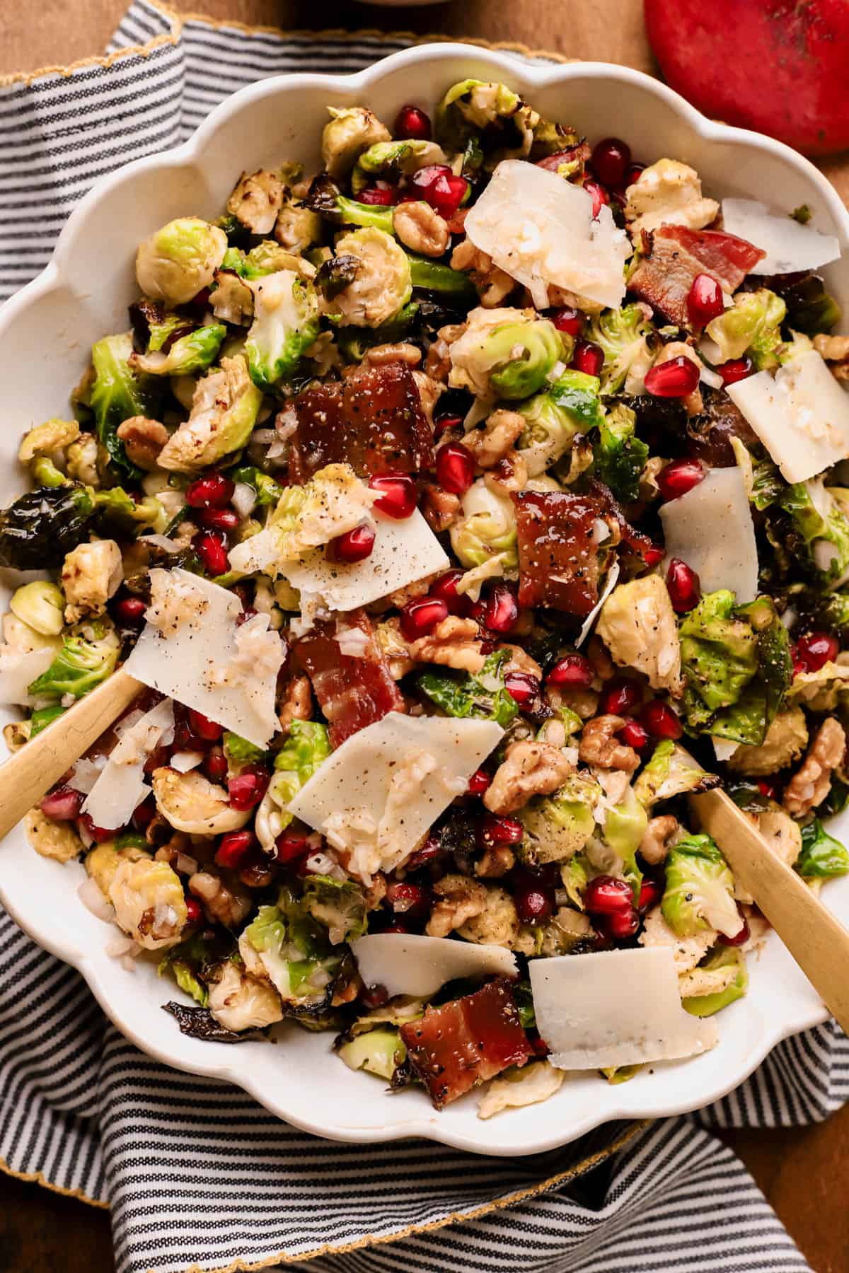 Warm Brussels sprouts salad with candied bacon, pomegranate seeds, and crunchy walnuts, all tossed in a apple cider vinaigrette. 